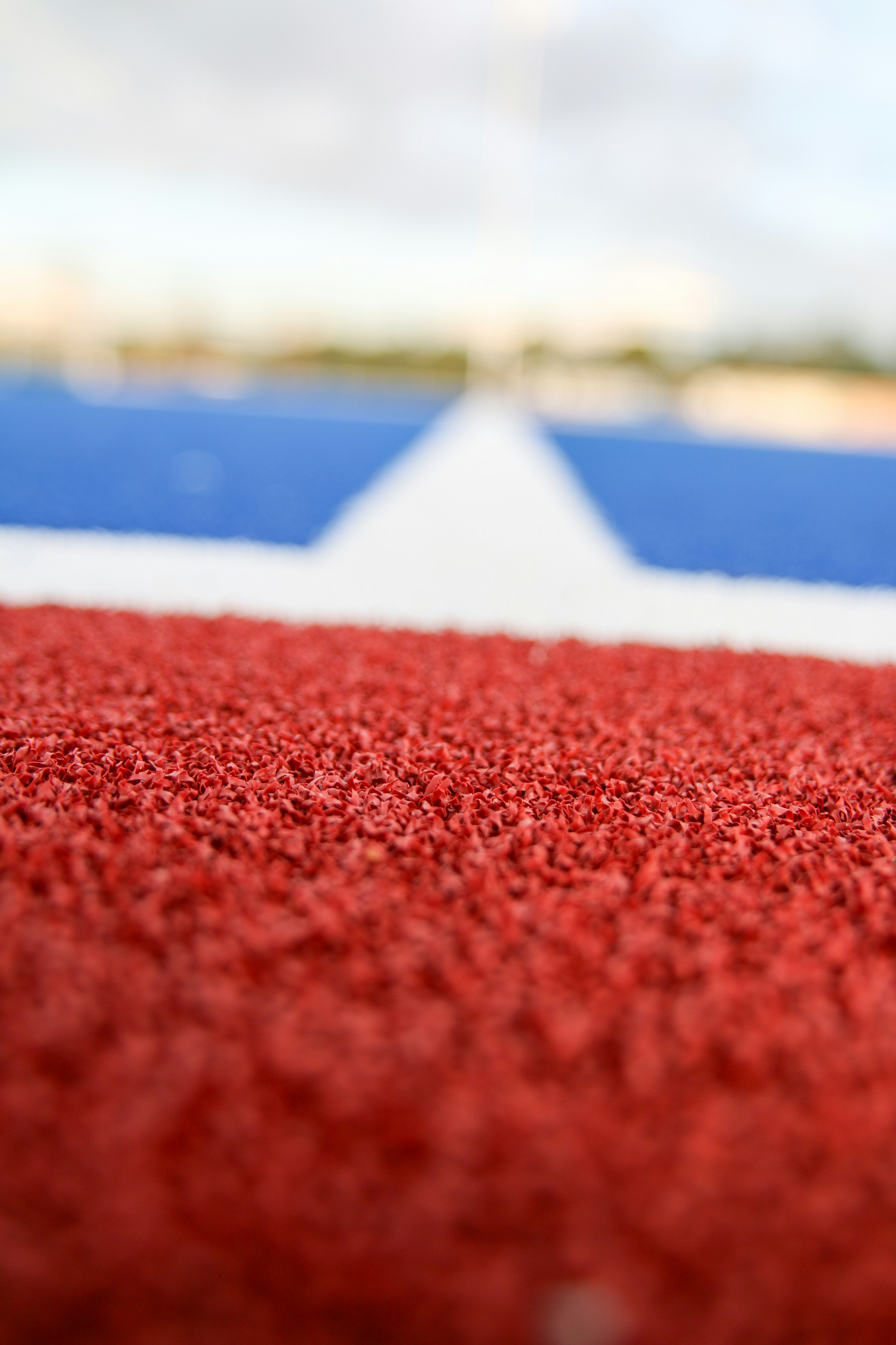 Red textured surface with white and blue stripes.
