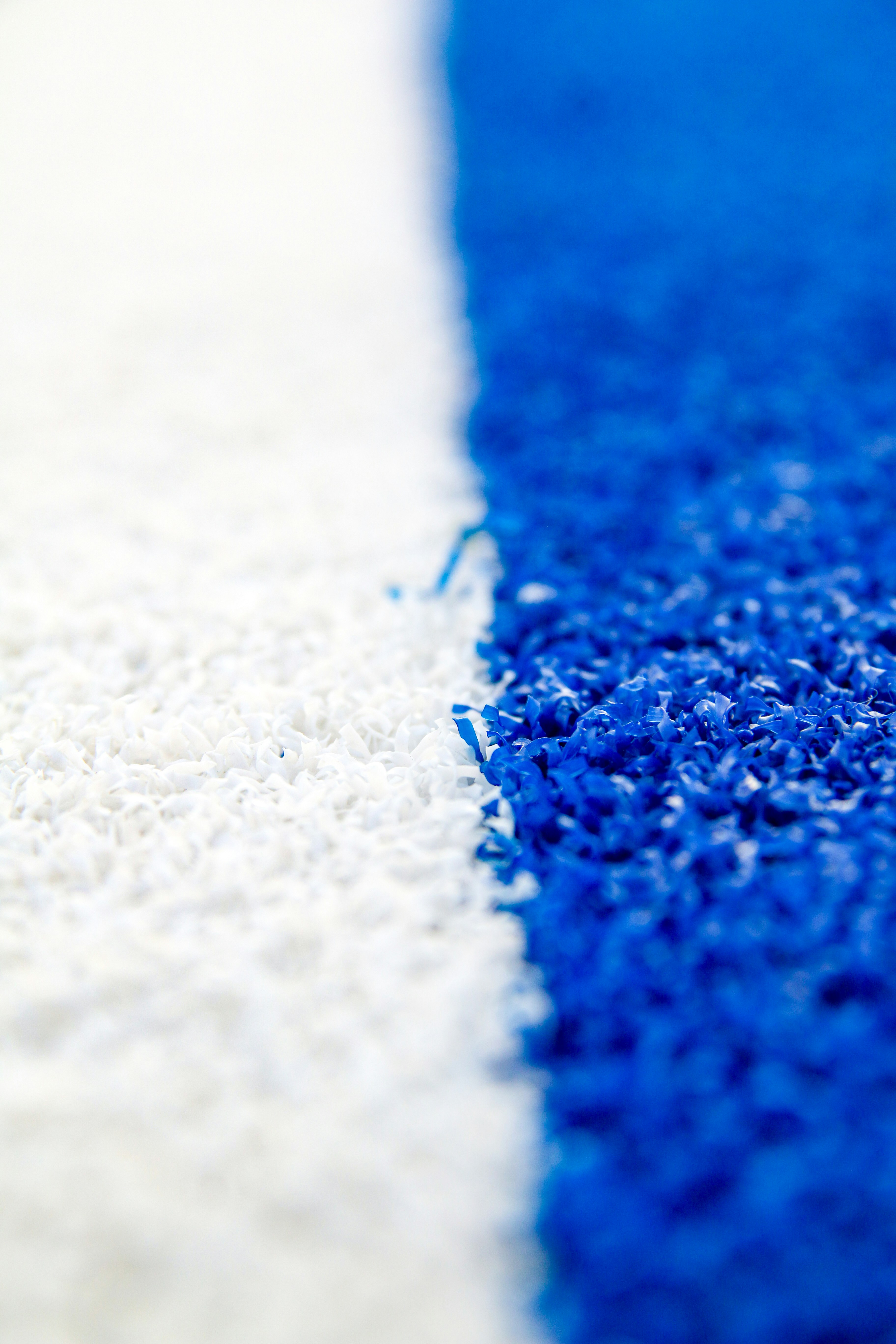 A textured surface divided into white and blue.