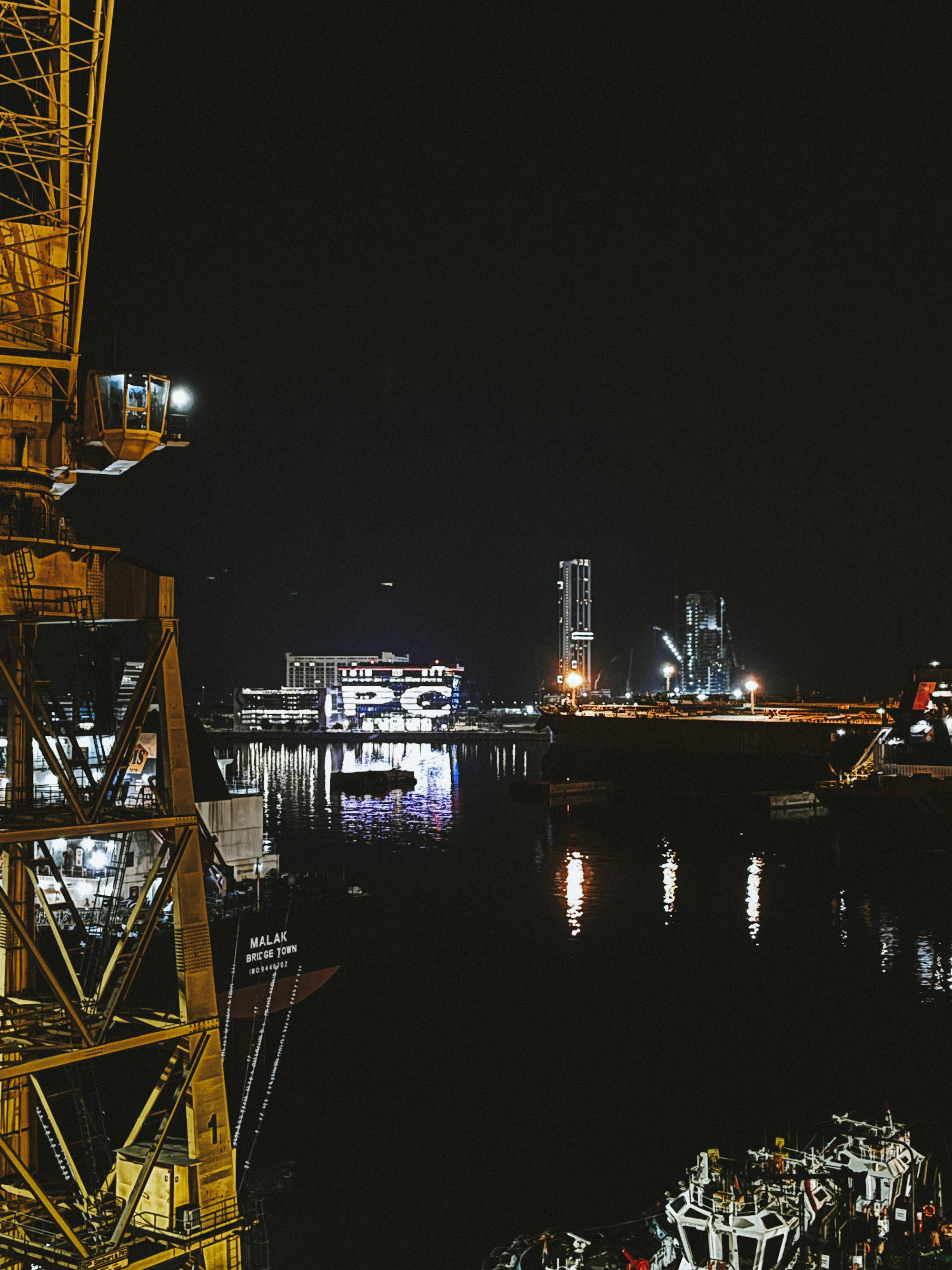 Industrial harbour infrastructure illuminated at night