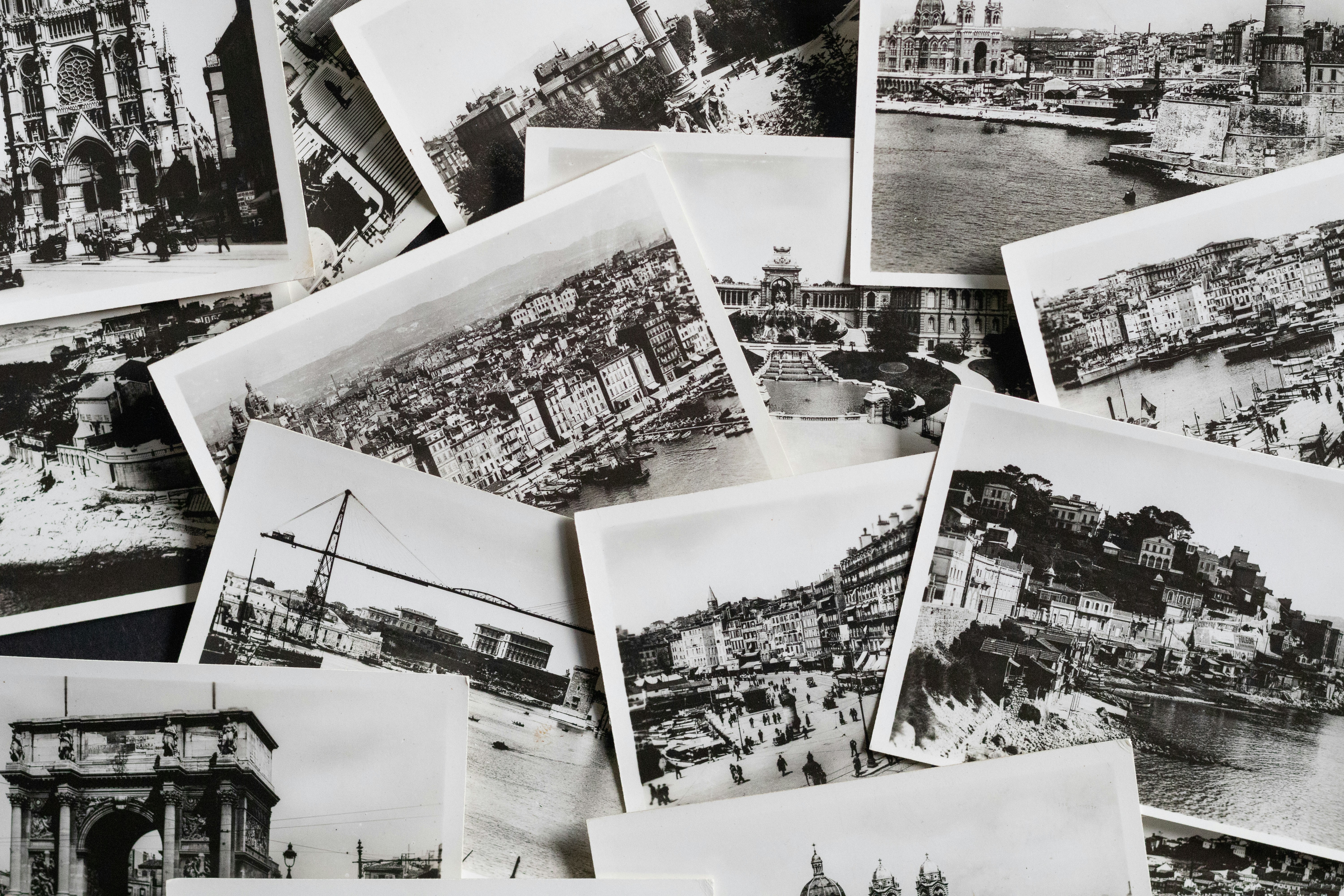 Scattered black and white postcards featuring historic european landmarks.