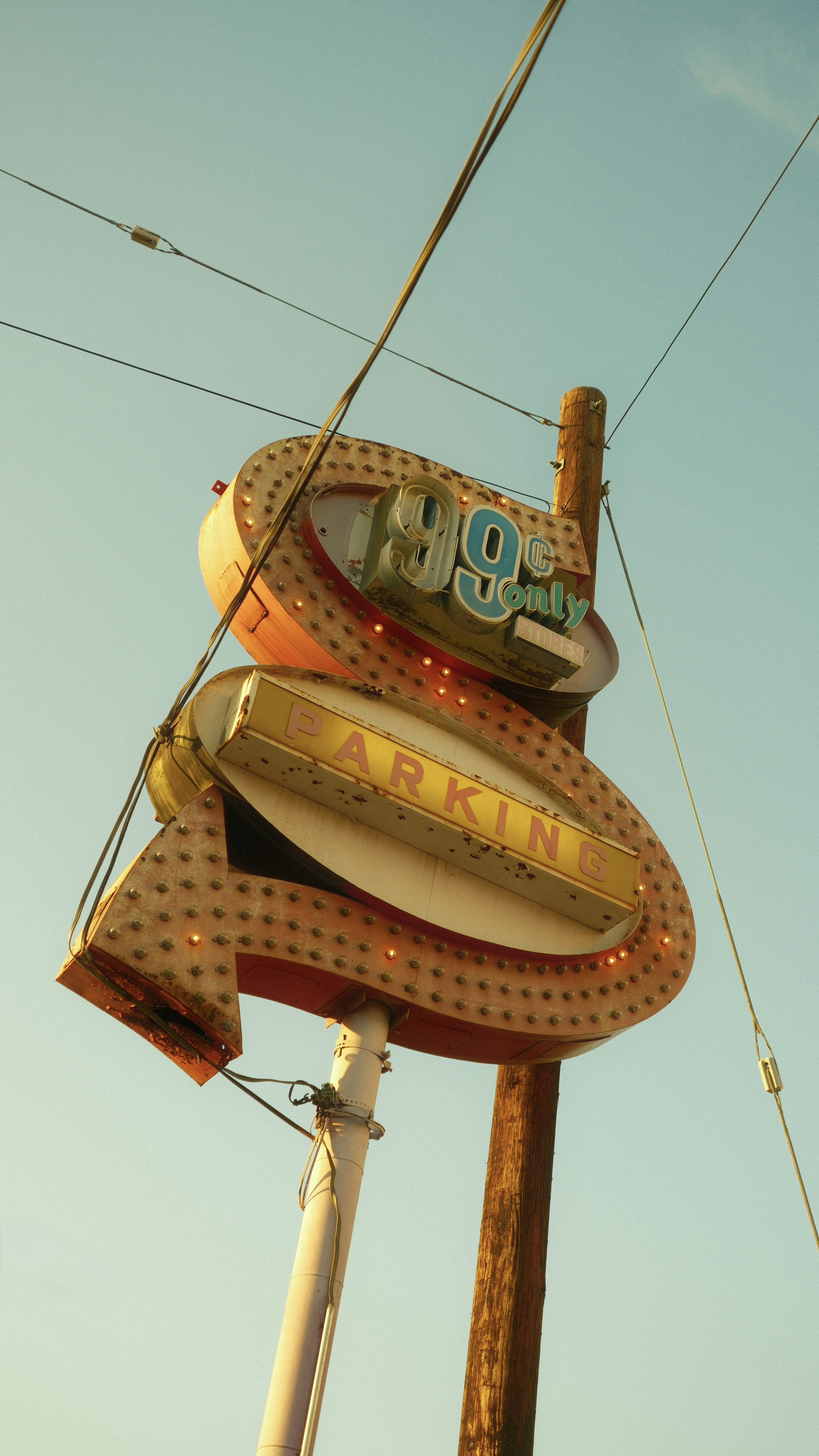 Weathered neon sign advertising 99¢ only and parking.