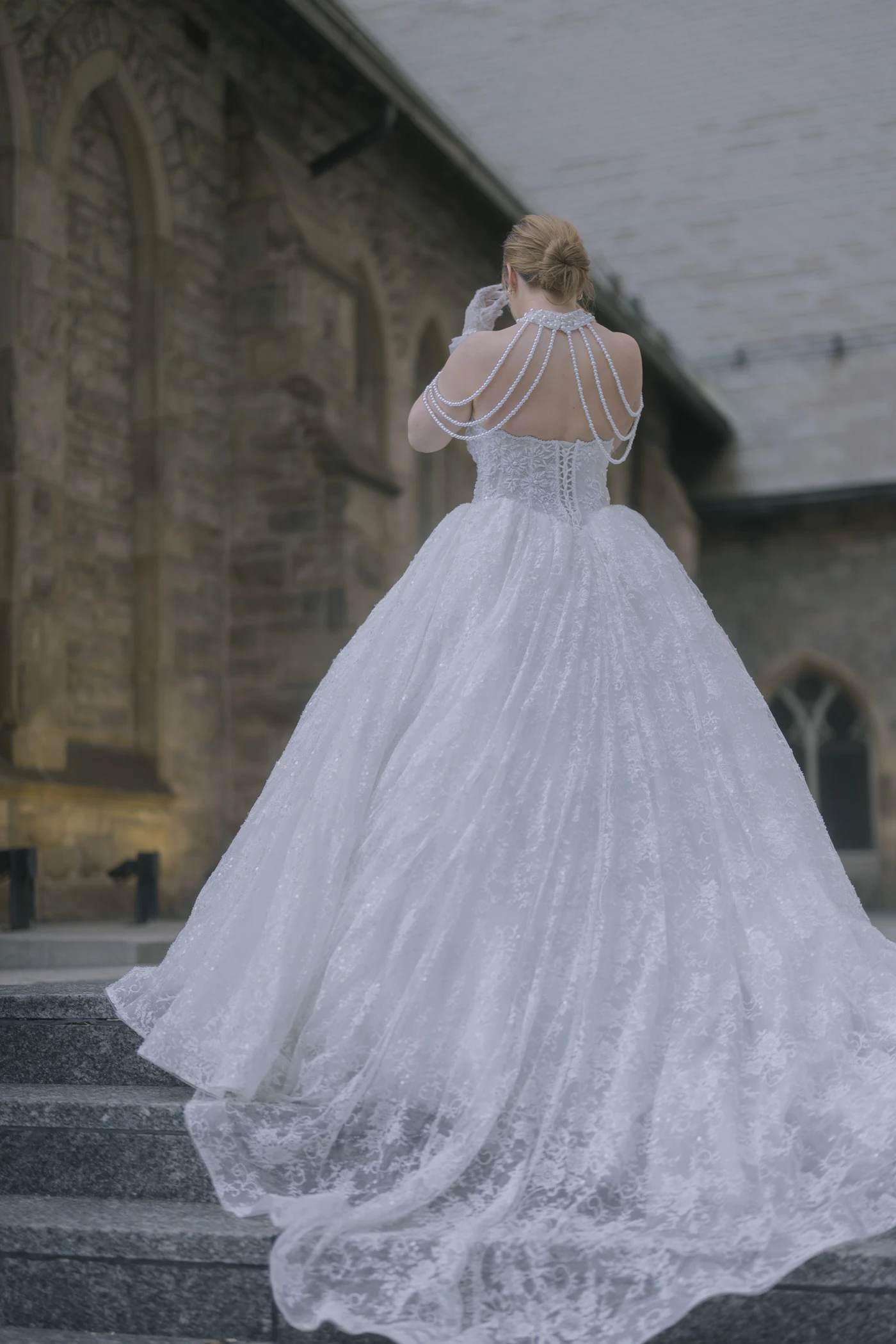 Trend forecast: 2025 wedding dress silhouettes — A bride showcases a dramatic ballgown silhouette with a cathedral train.