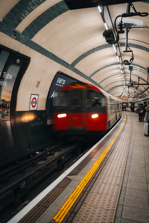 London Underground train arriving at a station platform with motion blur, a typical daily commute scene
