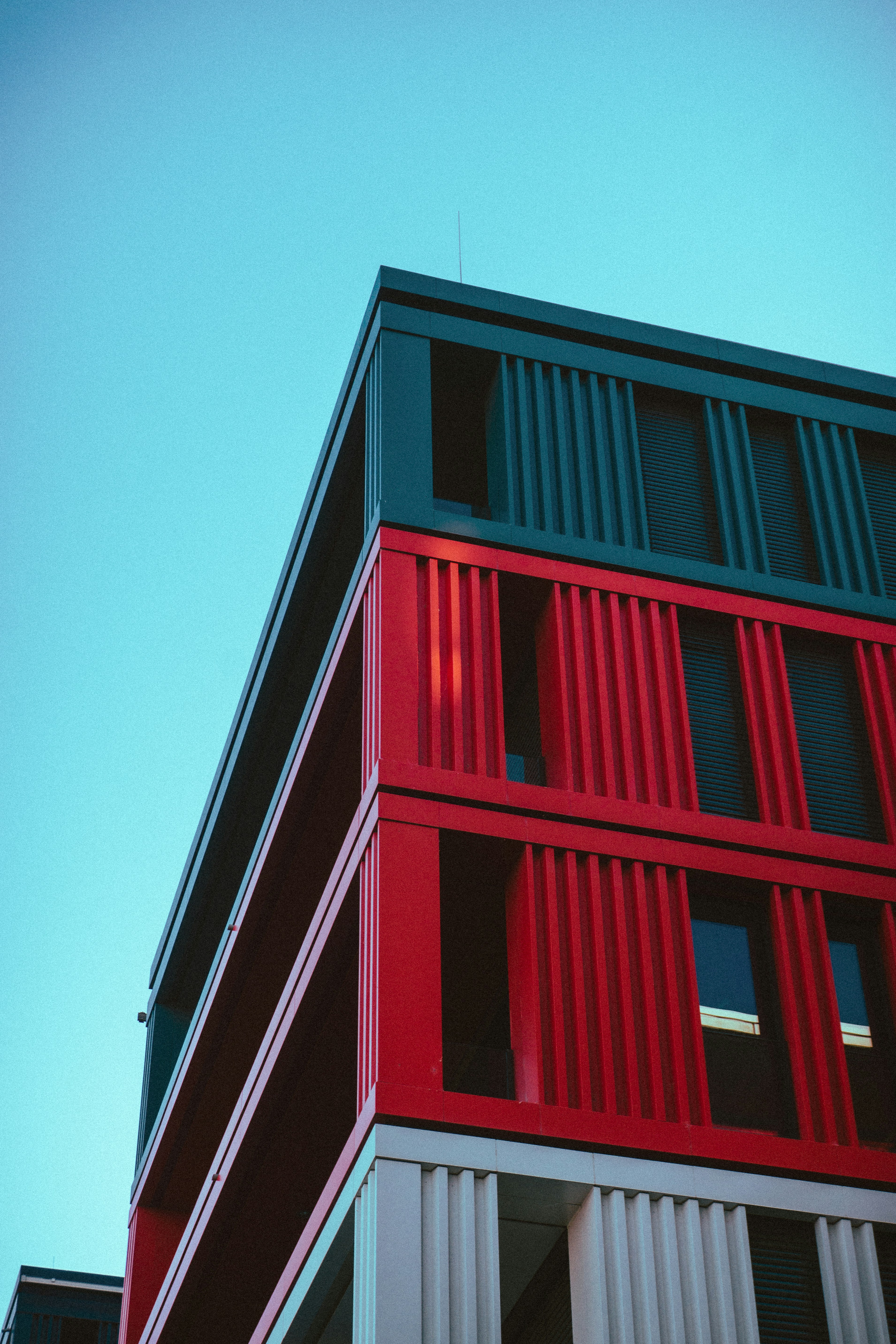 Colorful modern building facade against a clear blue sky.