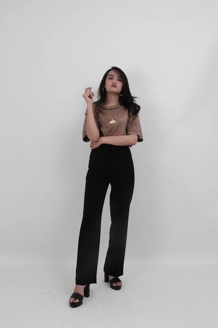 A woman in a brown tee and black trousers