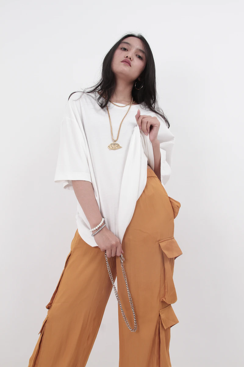 Oversized white tee with brown cargo pants