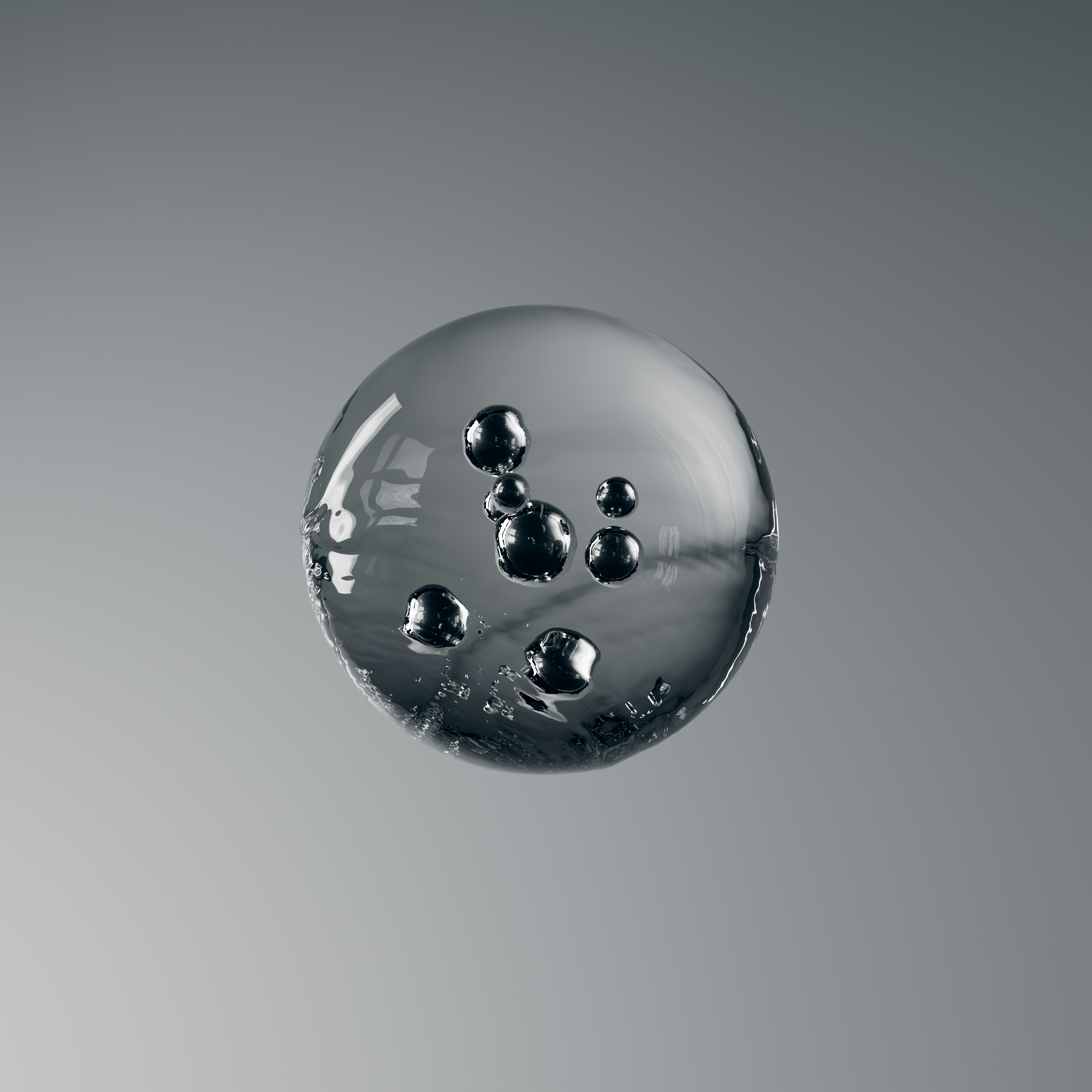 Glass sphere with dark bubbles on a grey background.