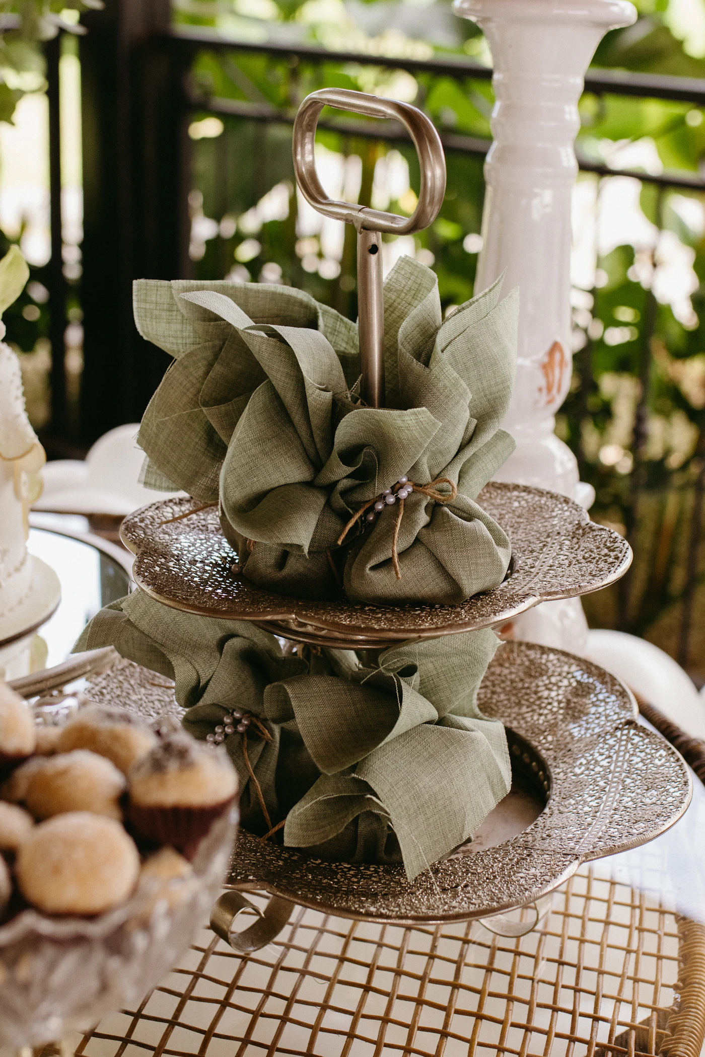 Fabric-wrapped party favors displayed on a dessert stand