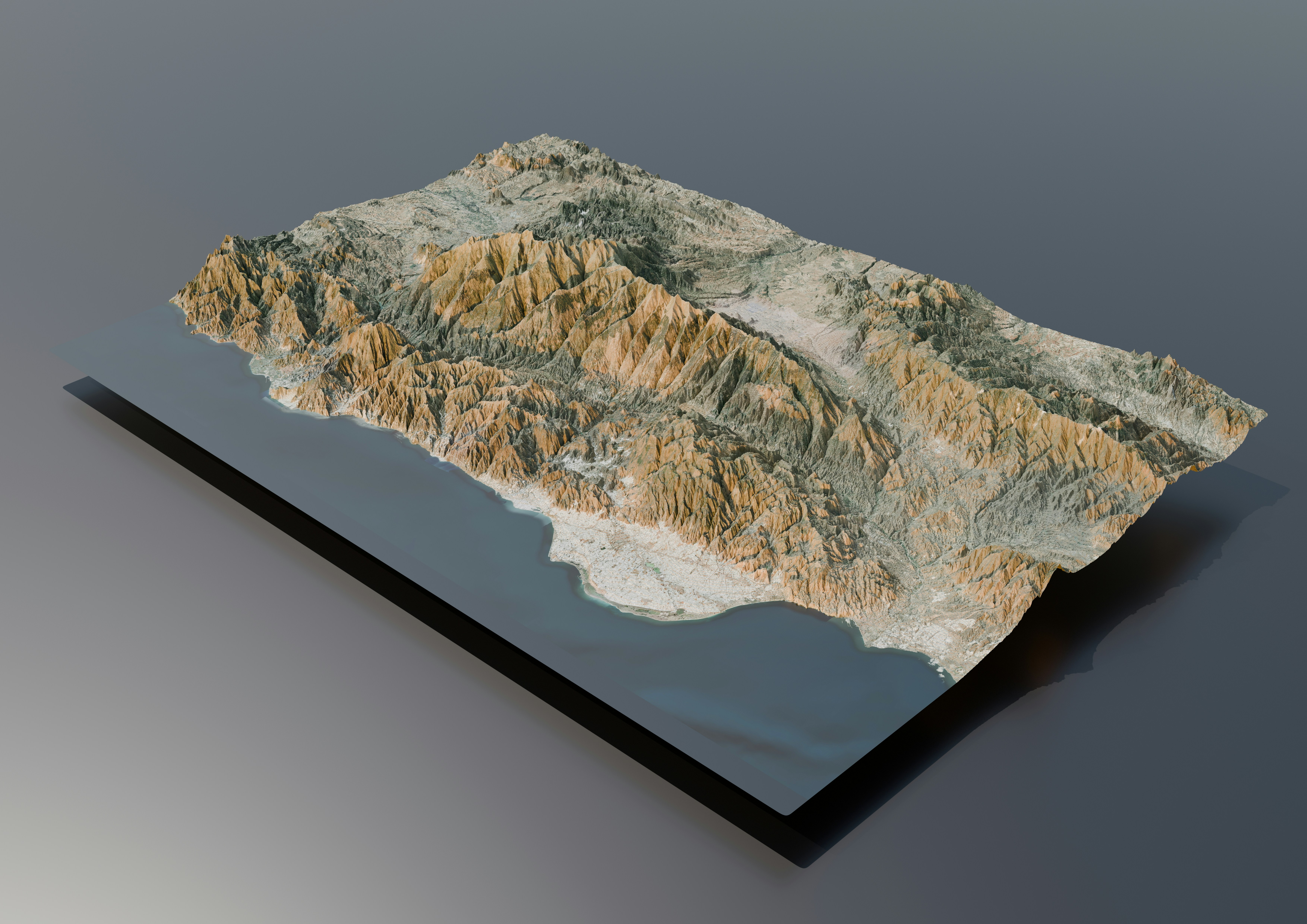 A 3D relief map of mountains on a reflective surface.