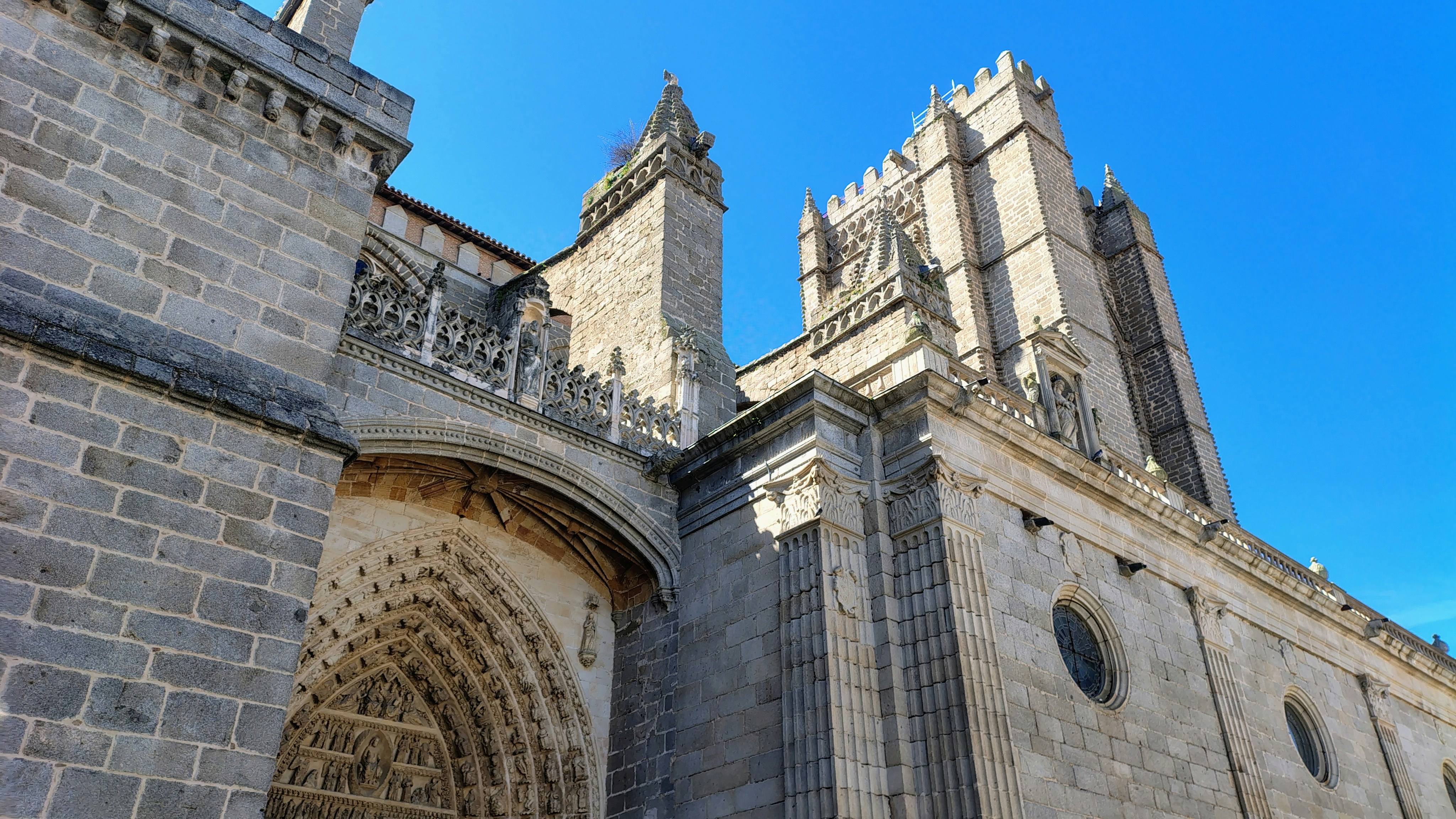 A grand stone cathedral against a clear blue sky.