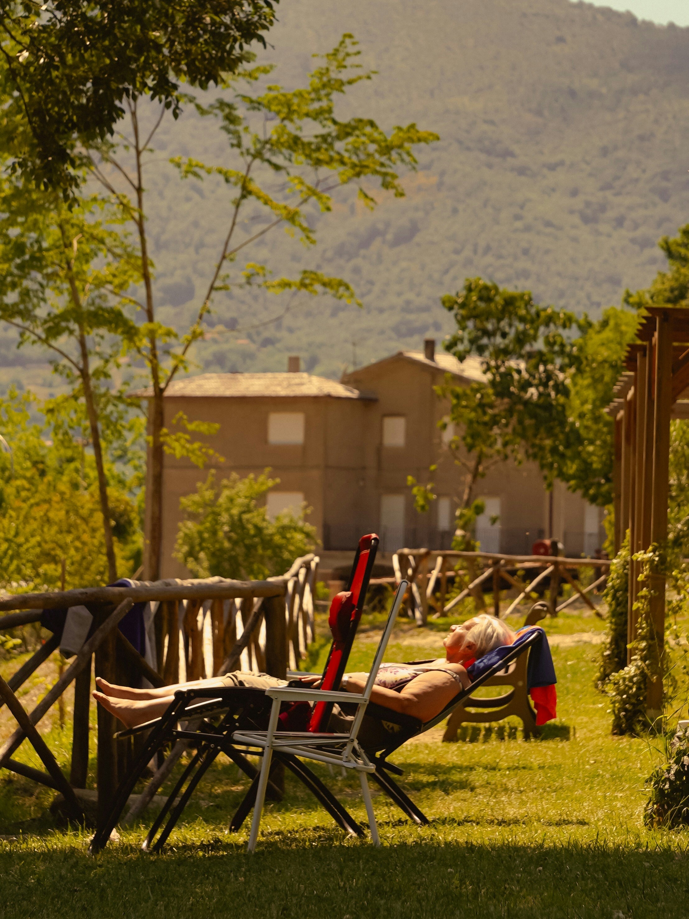 Man relaxing on a lounge chair in a garden