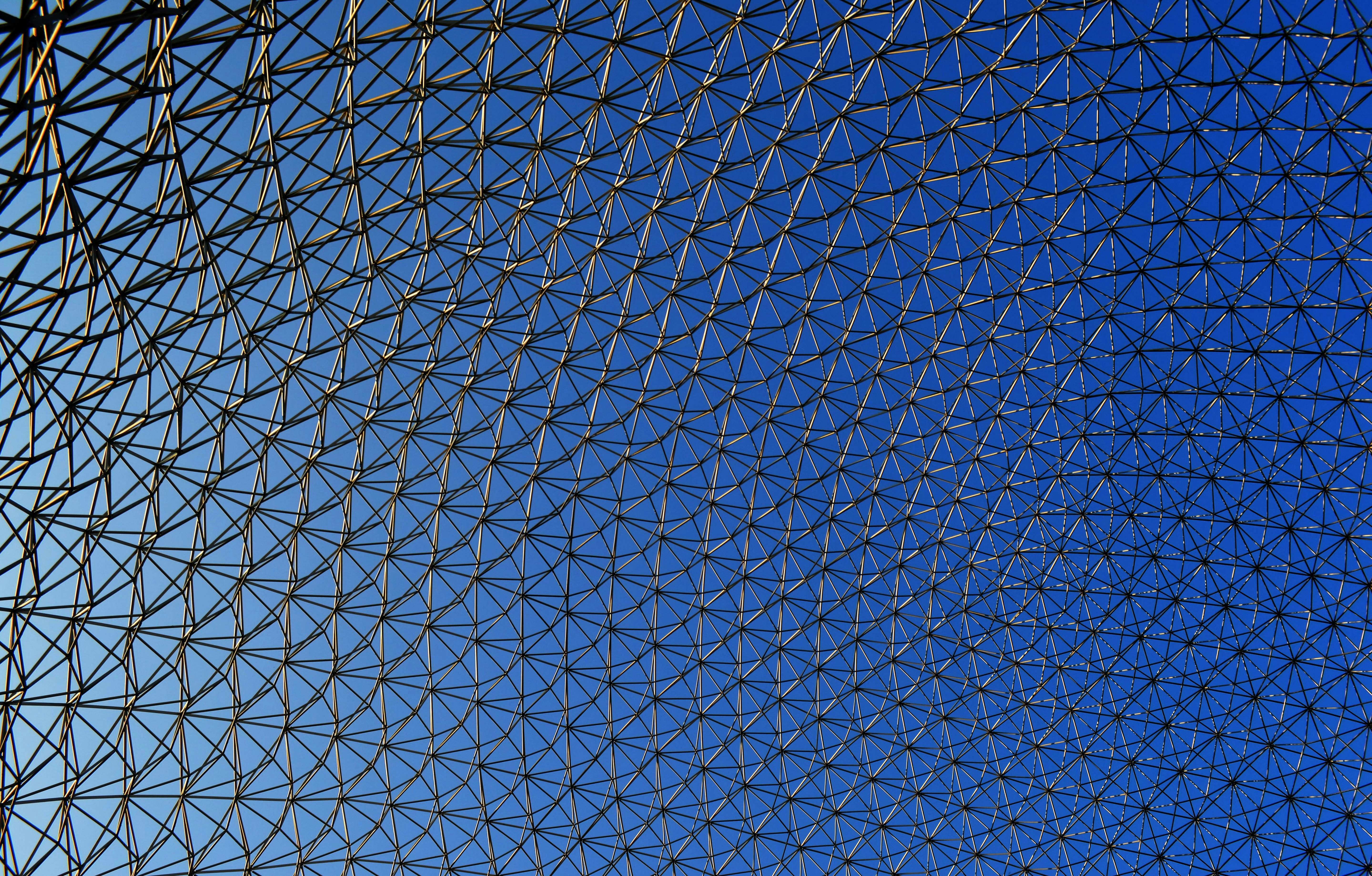 Geodesic dome structure against a clear blue sky.