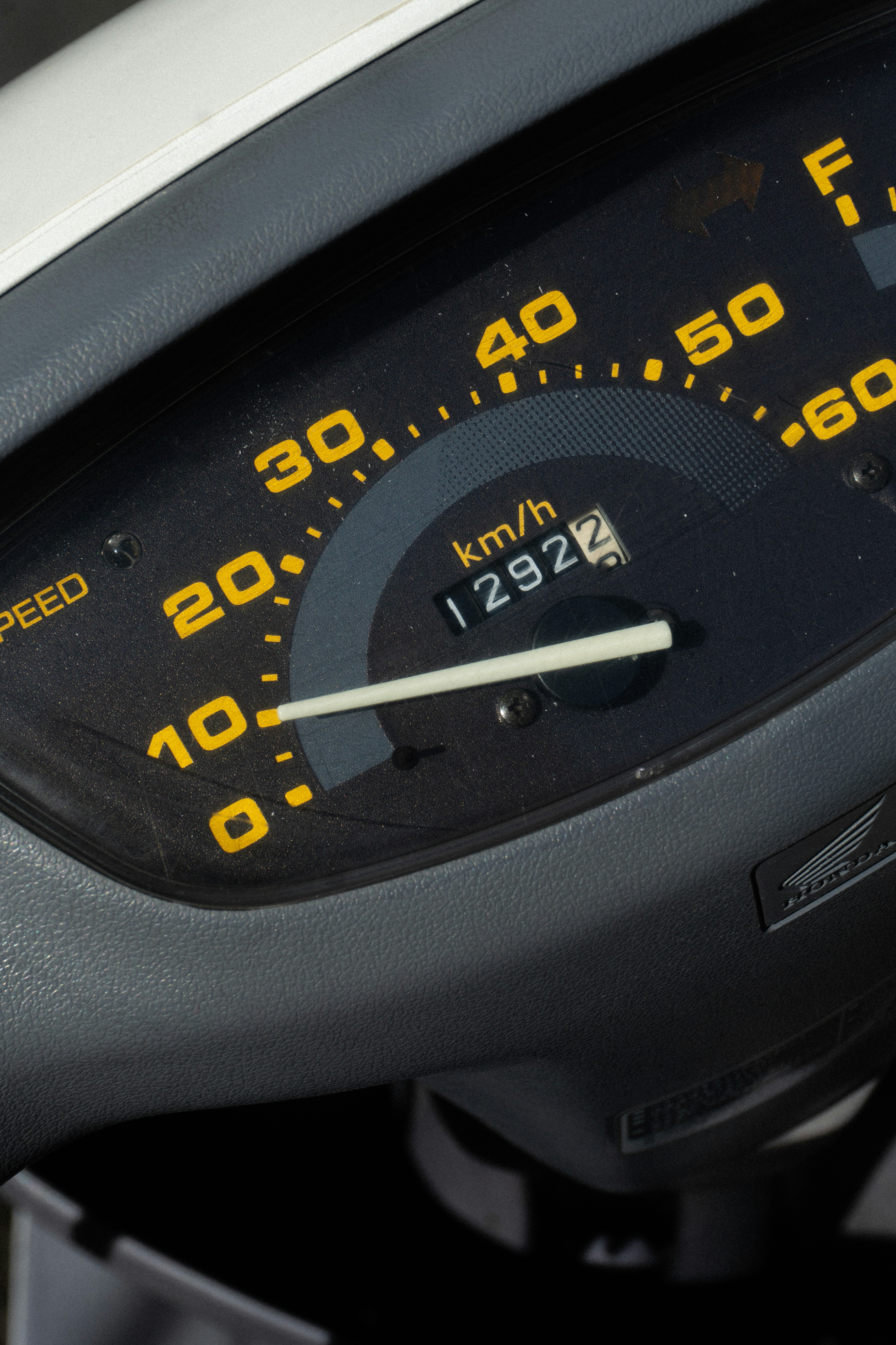 A scooter's speedometer and odometer showing 12922 kilometers