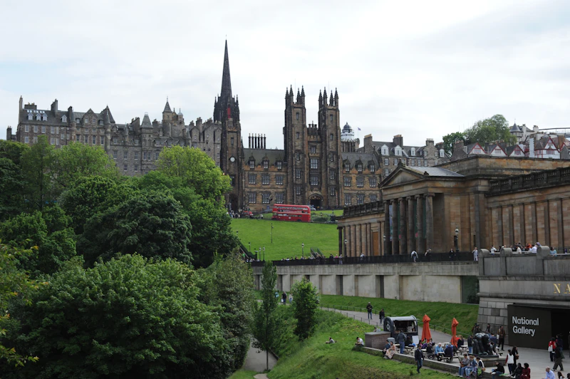 Historic Edinburgh city street with red bus