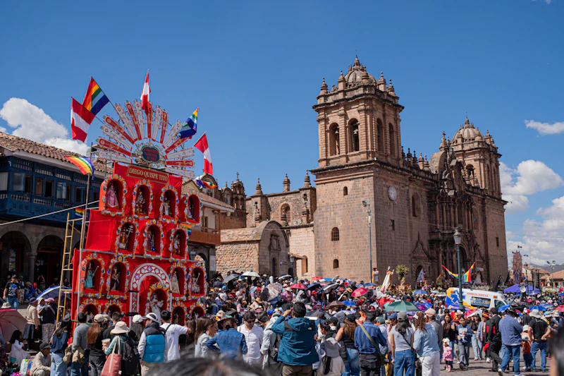 A festive religious procession crowd in Cusco's Plaza de Armas