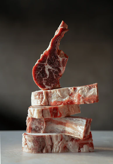 A stack of raw lamb chops with bones