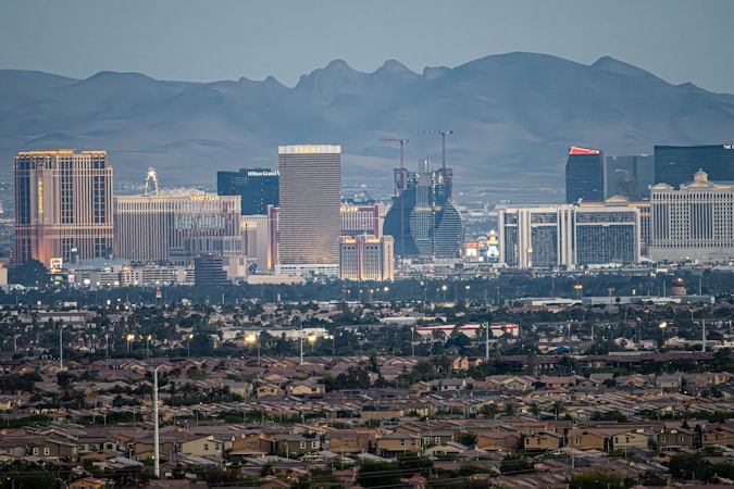 The Las Vegas cityscape at dusk with mountains behind it, the wider Clark County market affected by short-term rental policy