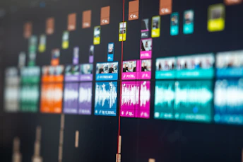 Colorful video editing timeline with audio waveforms and video clips