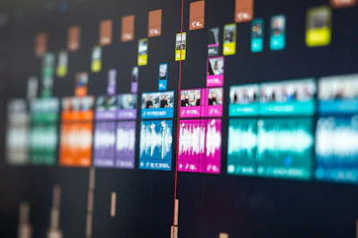 Colorful video editing timeline with audio waveforms and video clips
