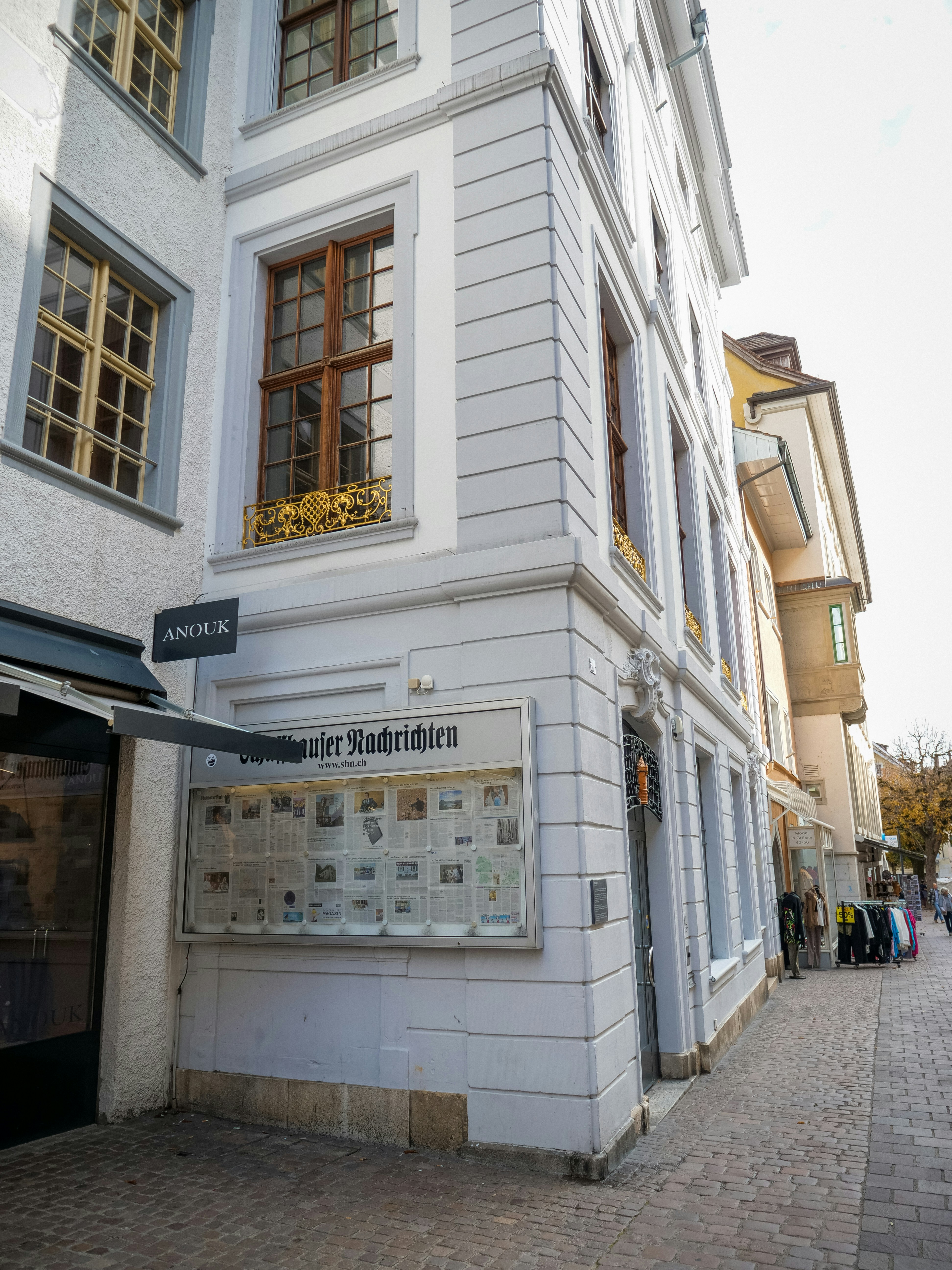 Historic building with display board on a narrow european street.