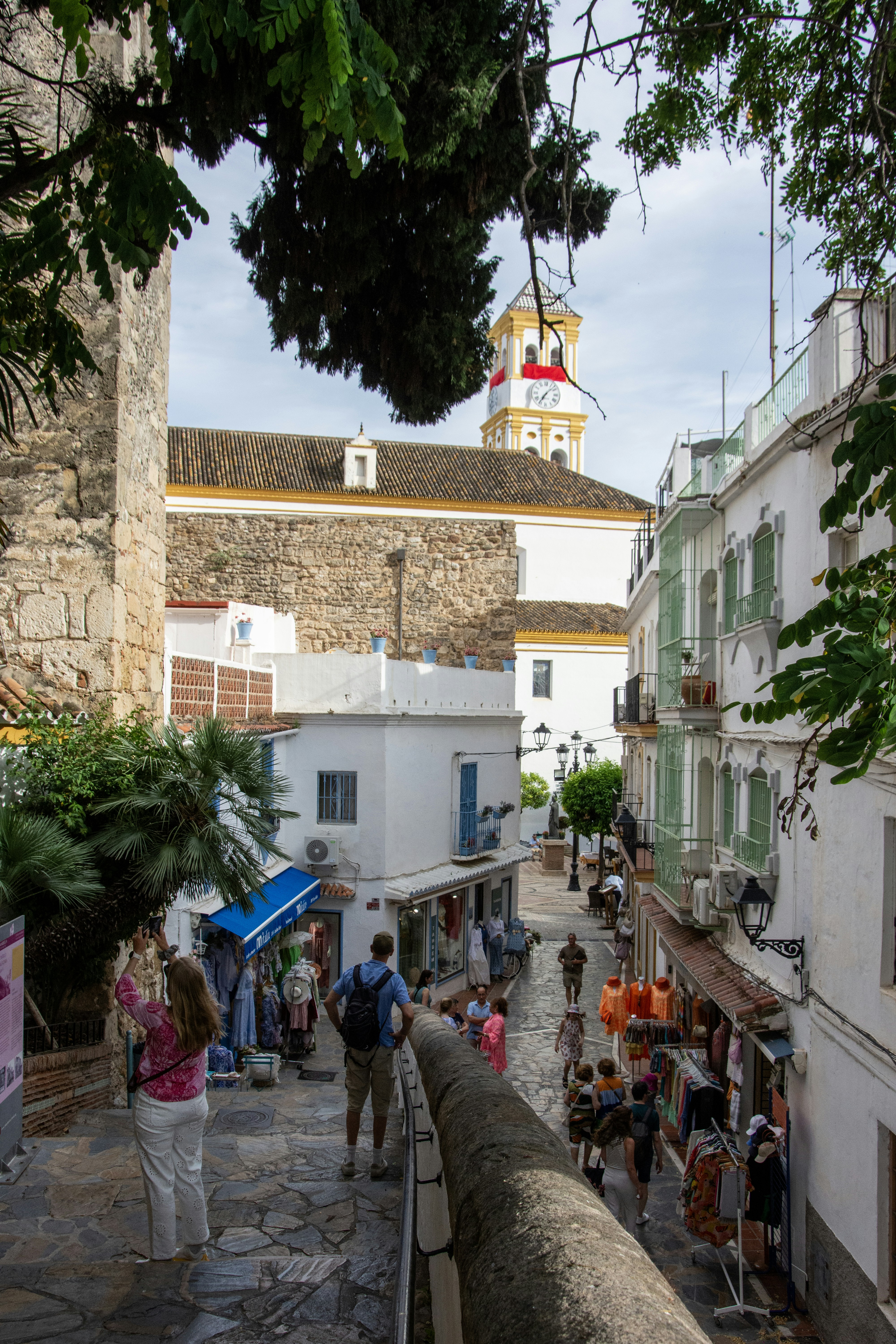 People walk along a narrow street in a european town.