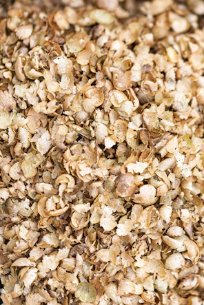 A large pile of dried, light brown hops.