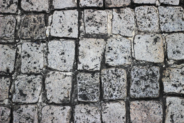 Weathered, square stone blocks forming a textured surface