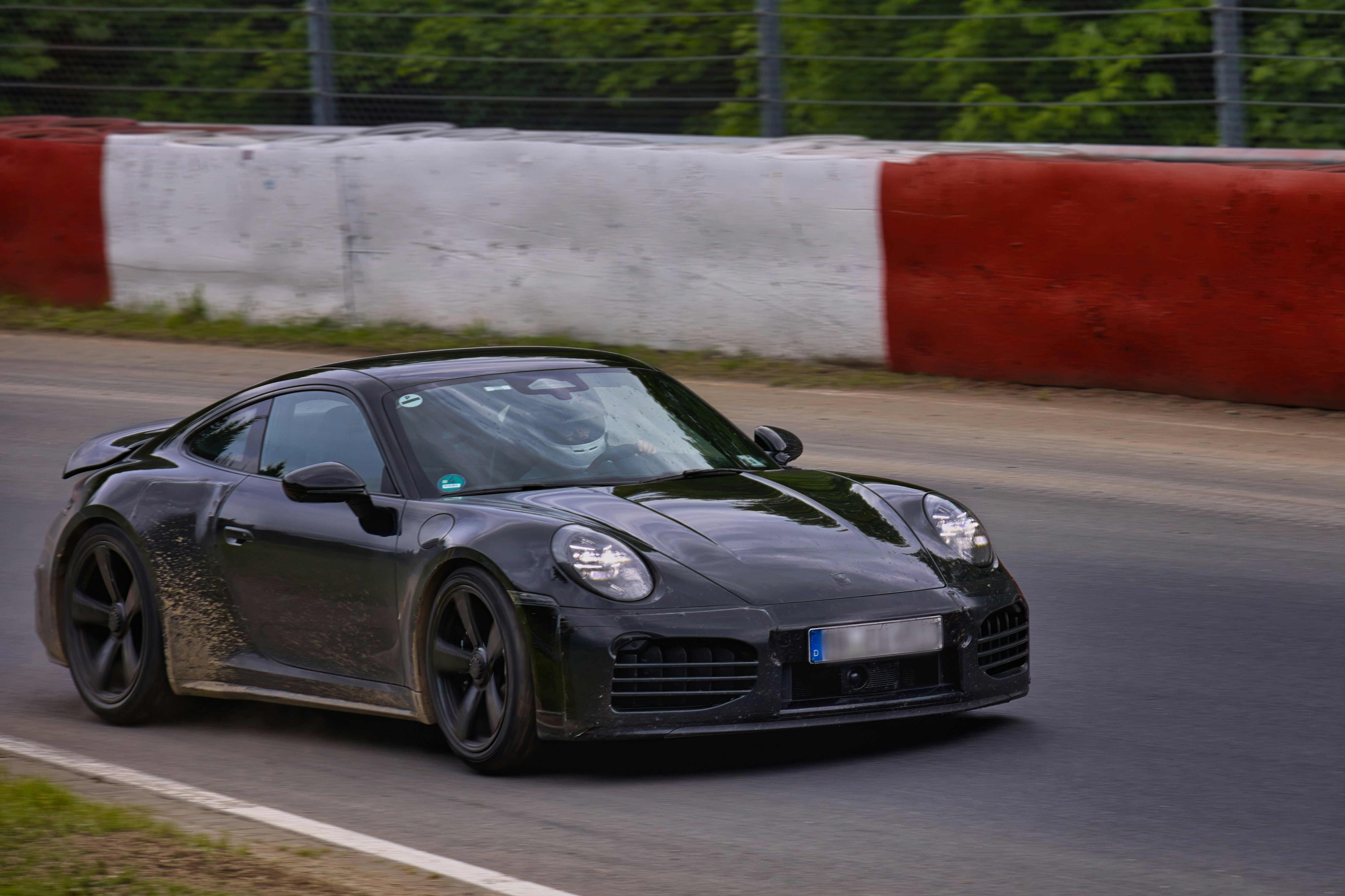 Black porsche sports car on a race track.