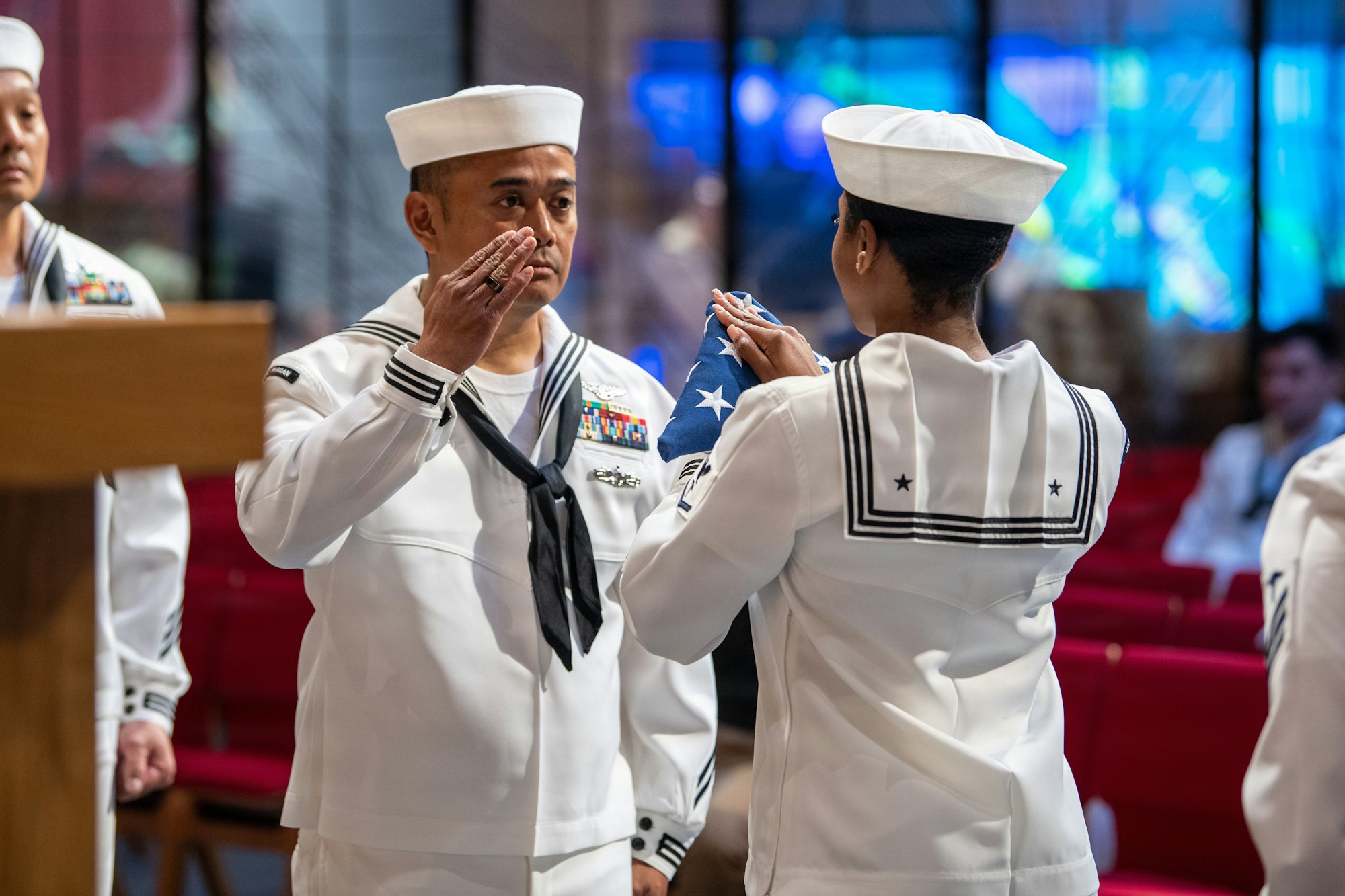 Military honor guard folding an American flag