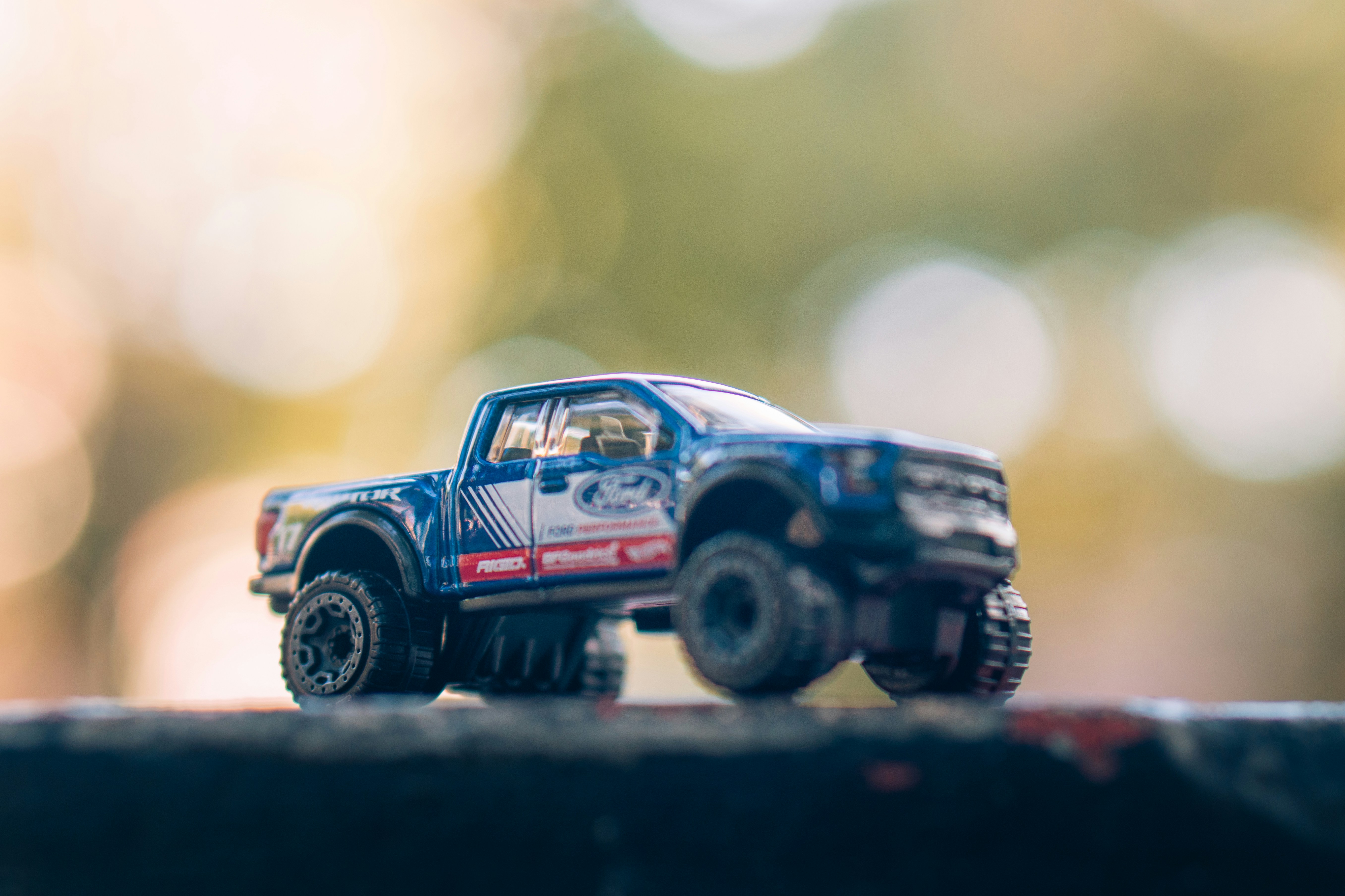 Detailed blue toy truck against a bokeh background.