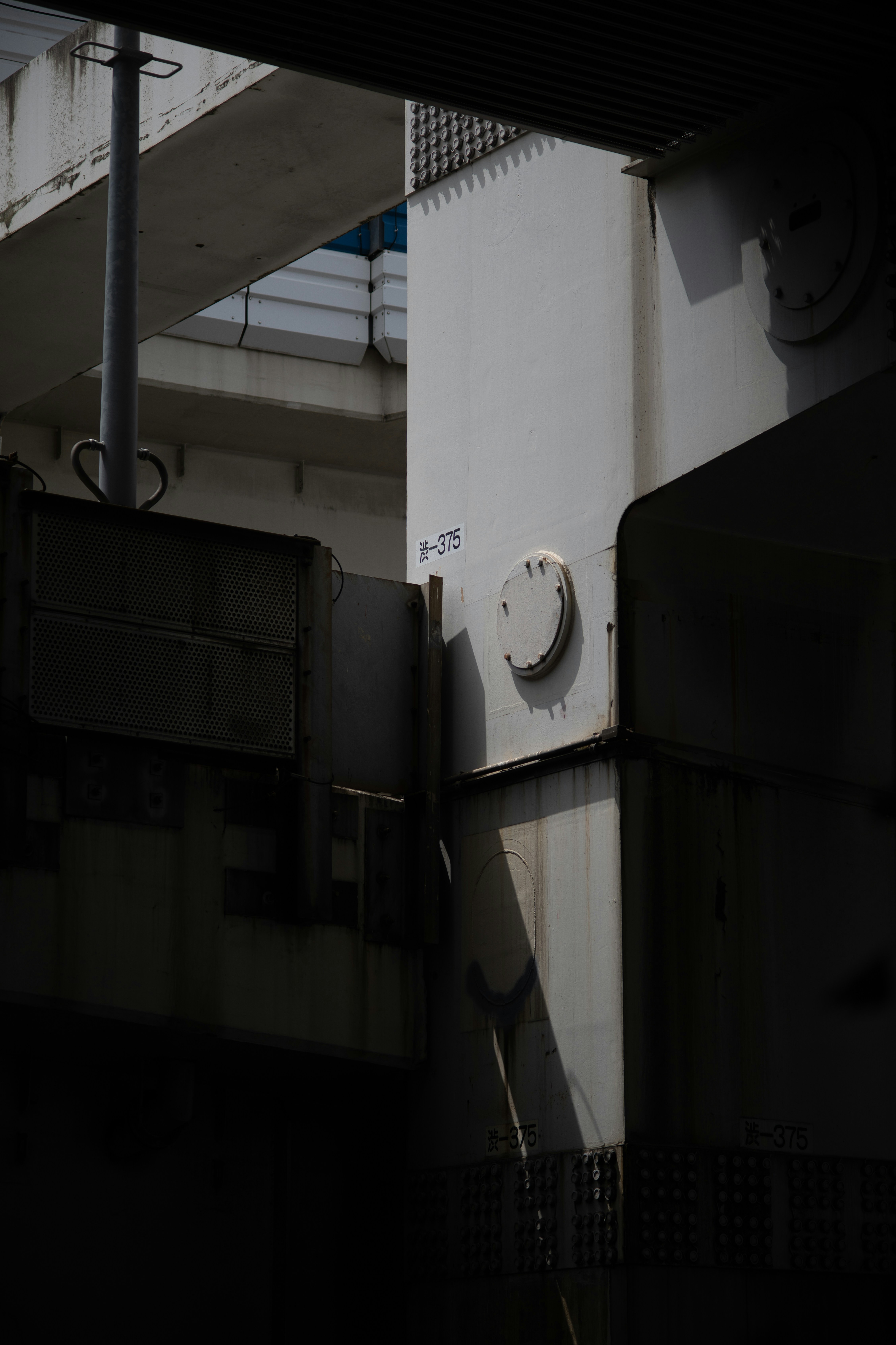 Industrial steel beams with strong shadows and light.