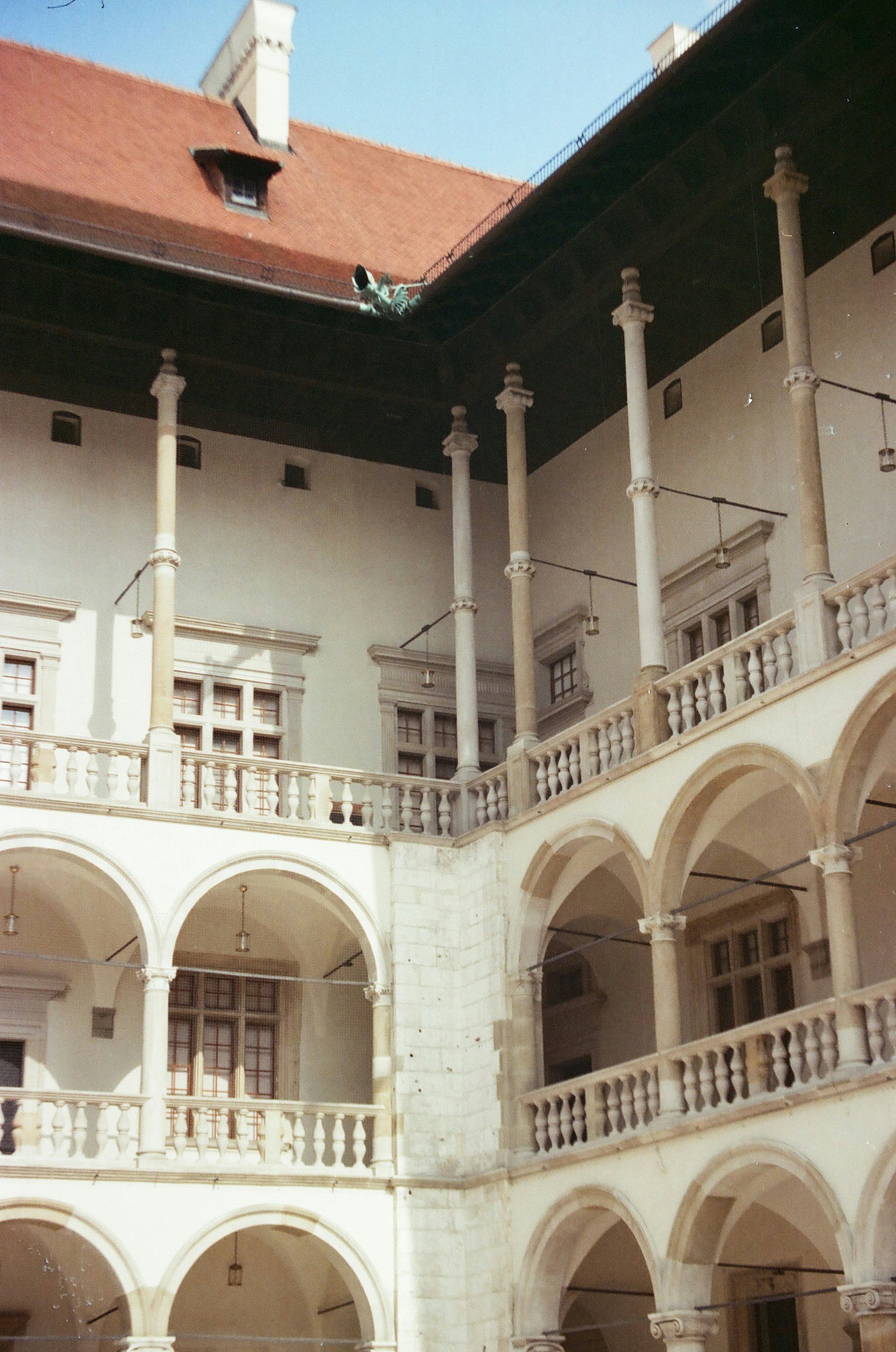Ornate historical courtyard with arched balconies and columns