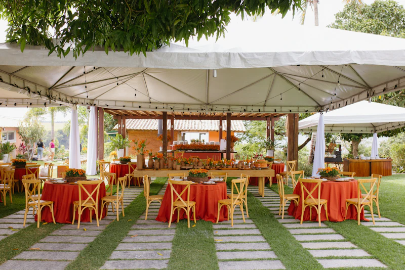 An outdoor event under white tents