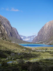Turquoise lake in a mountain valley under blue sky