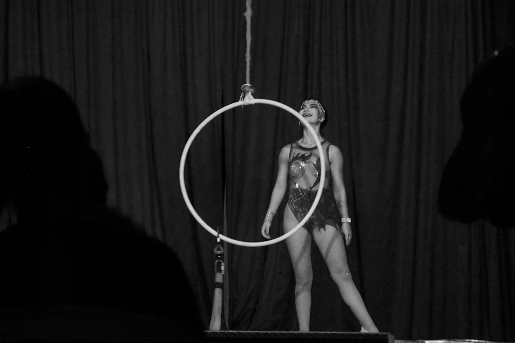 Aerialist posing gracefully on lyra hoop