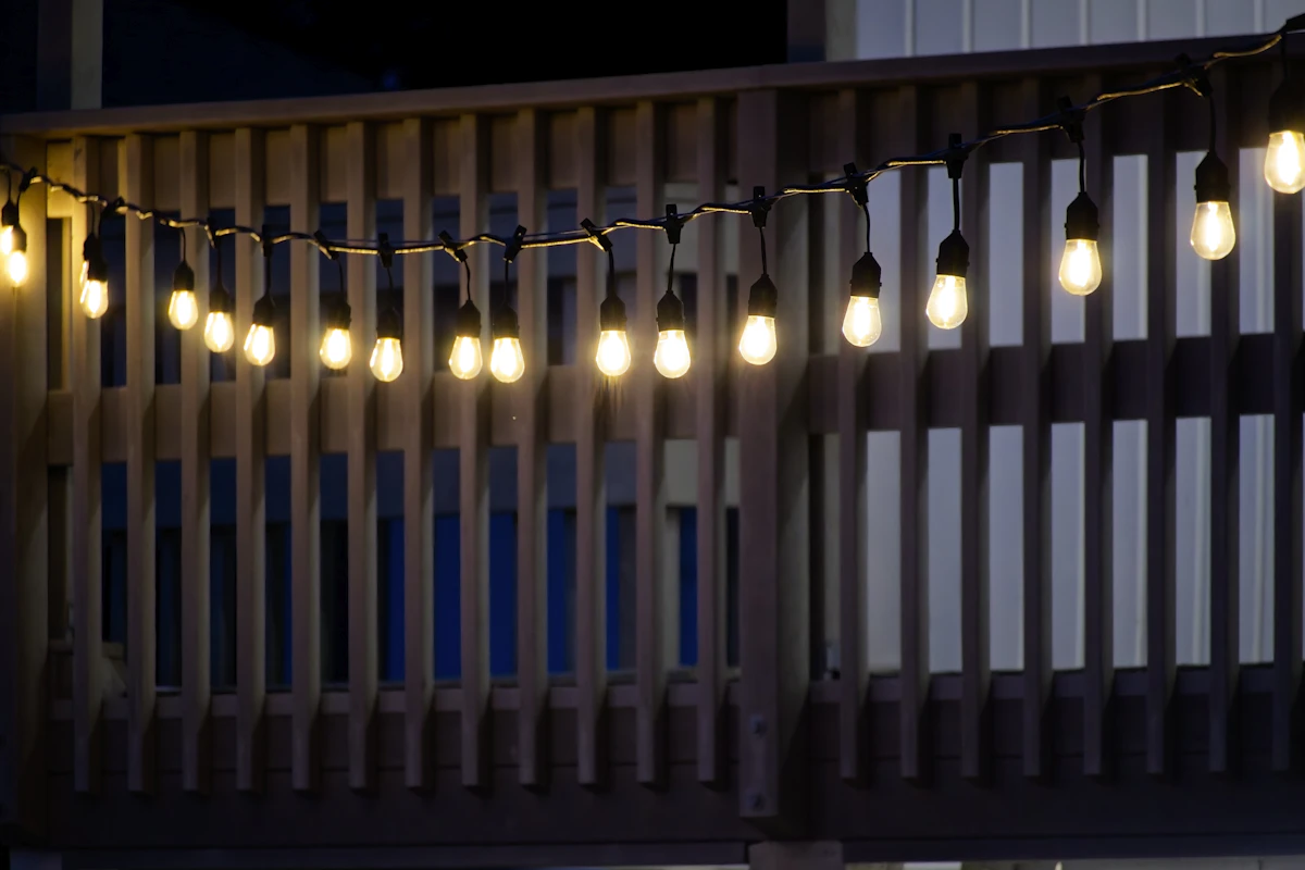 Deck railing with string lights at night