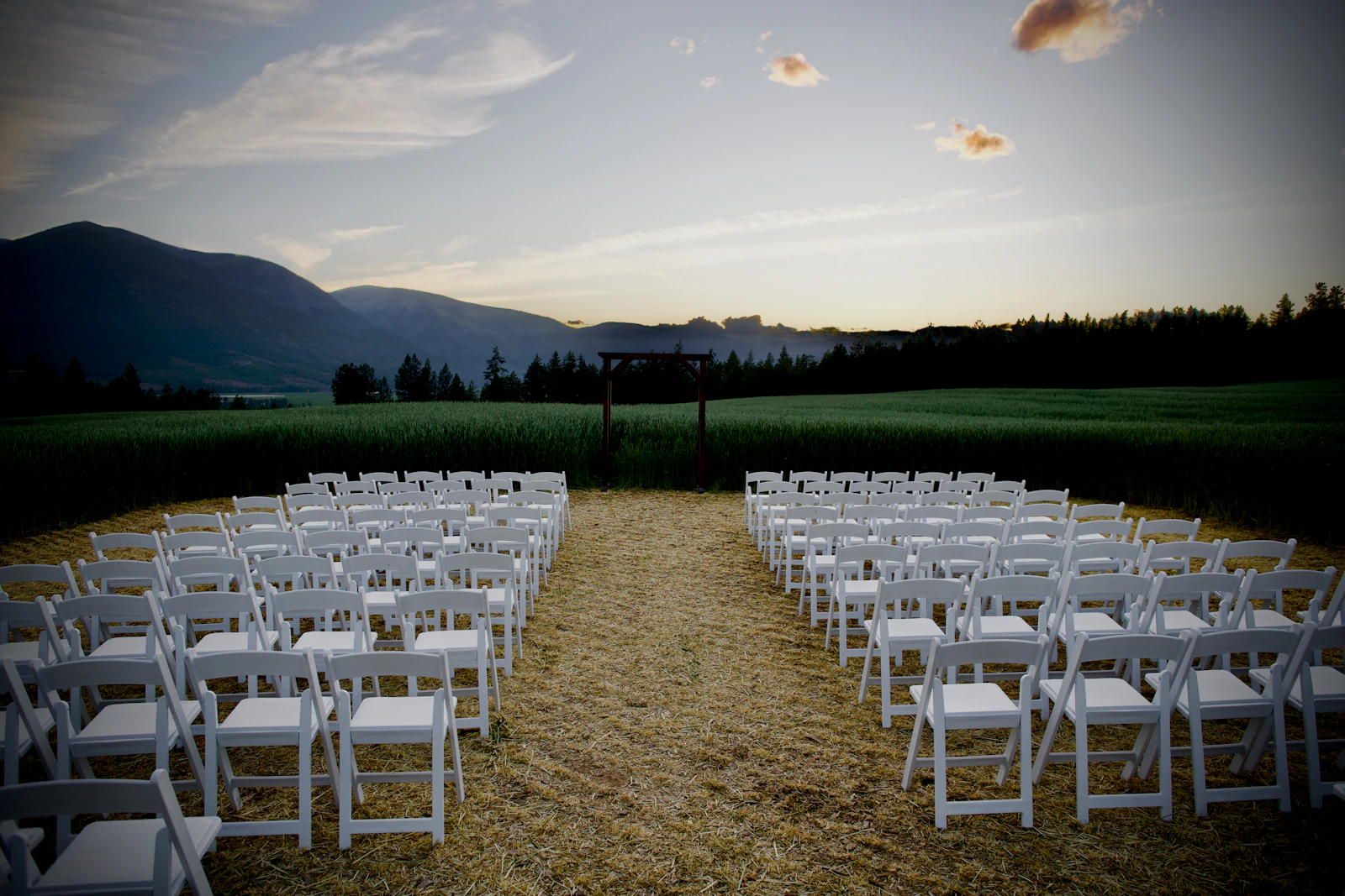 Ceremony chairs facing mountains at dusk