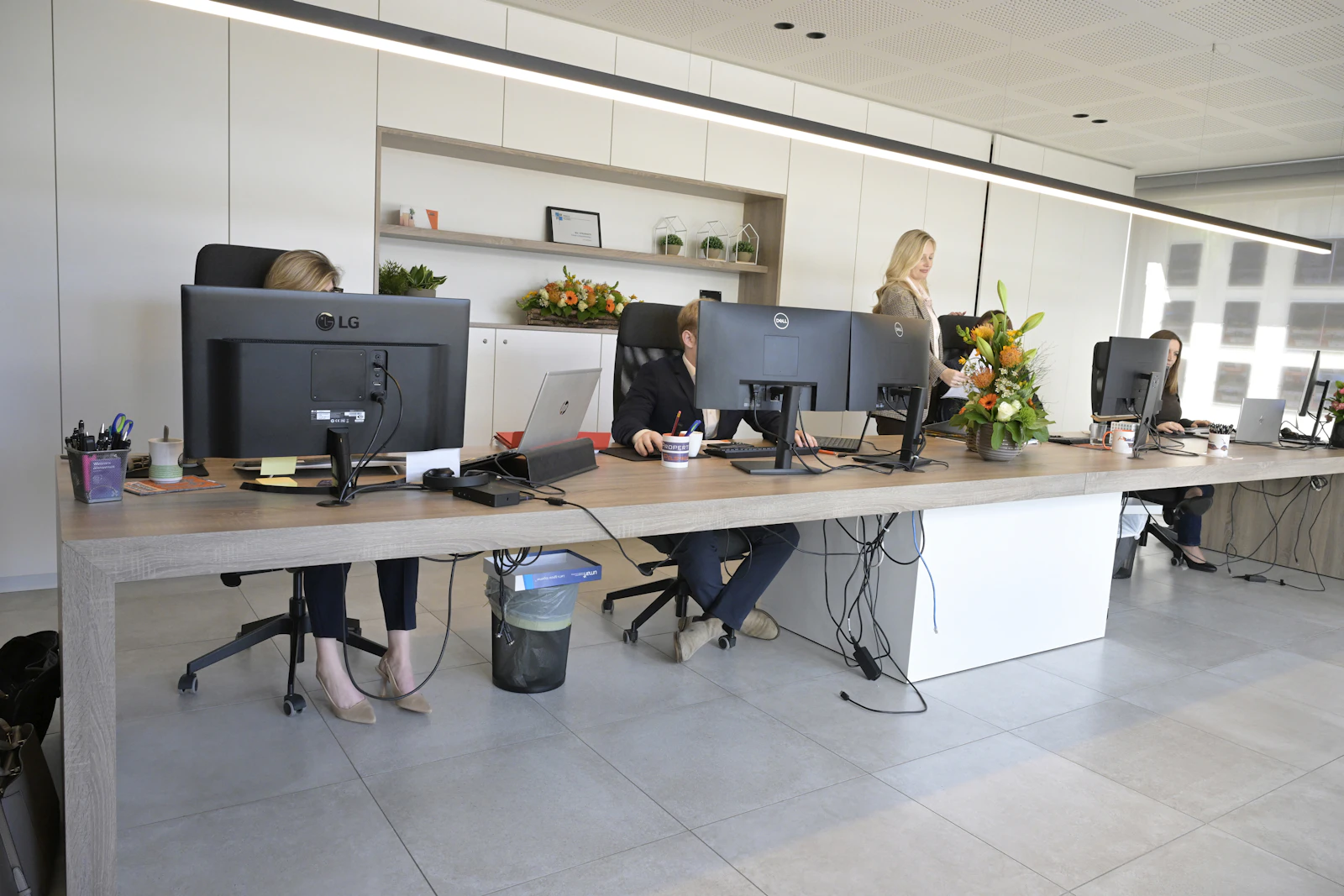 Business professionals working at desks in a modern open-plan enterprise office