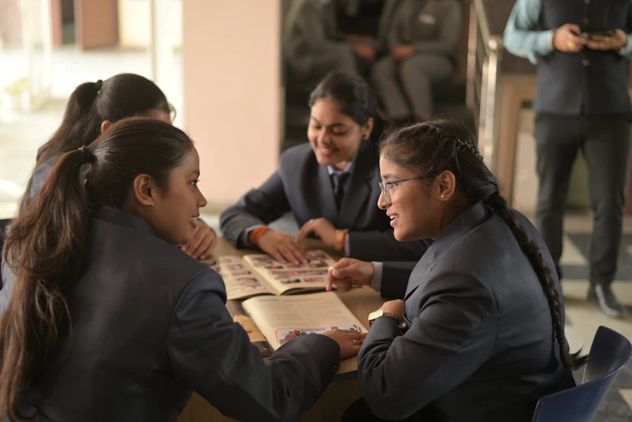 Vidyodaya Academy students and a mentor reviewing material together