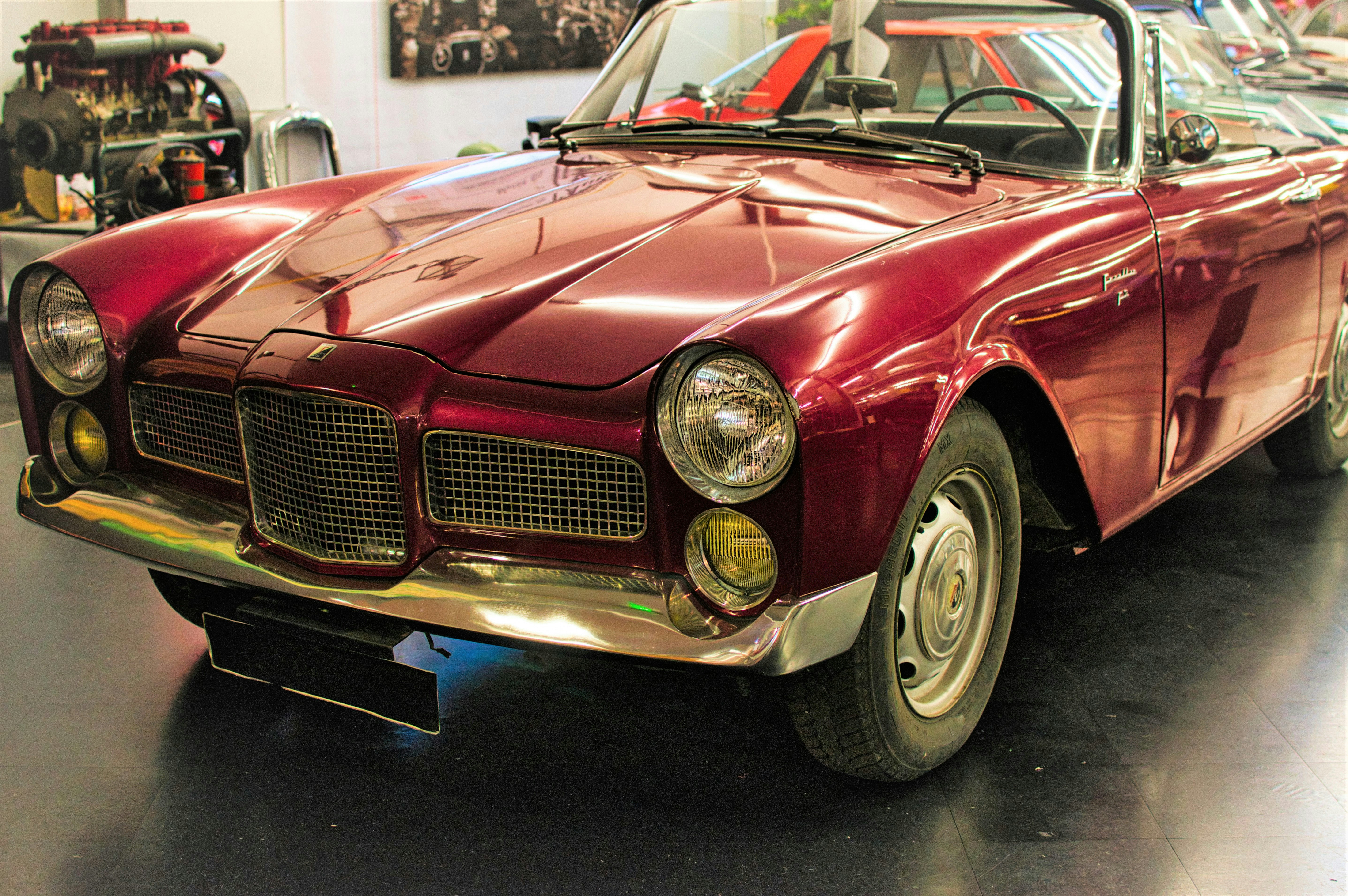 A vintage red convertible car parked indoors. photo – Free Design Image ...