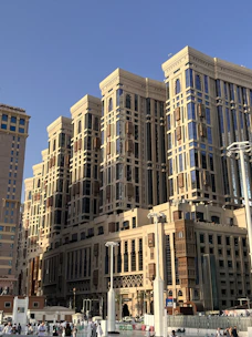 Ornate, multi-story buildings towering under a bright blue sky.