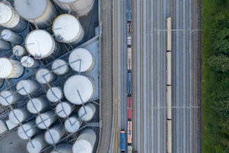 Overhead view of industrial silos and a train on tracks.