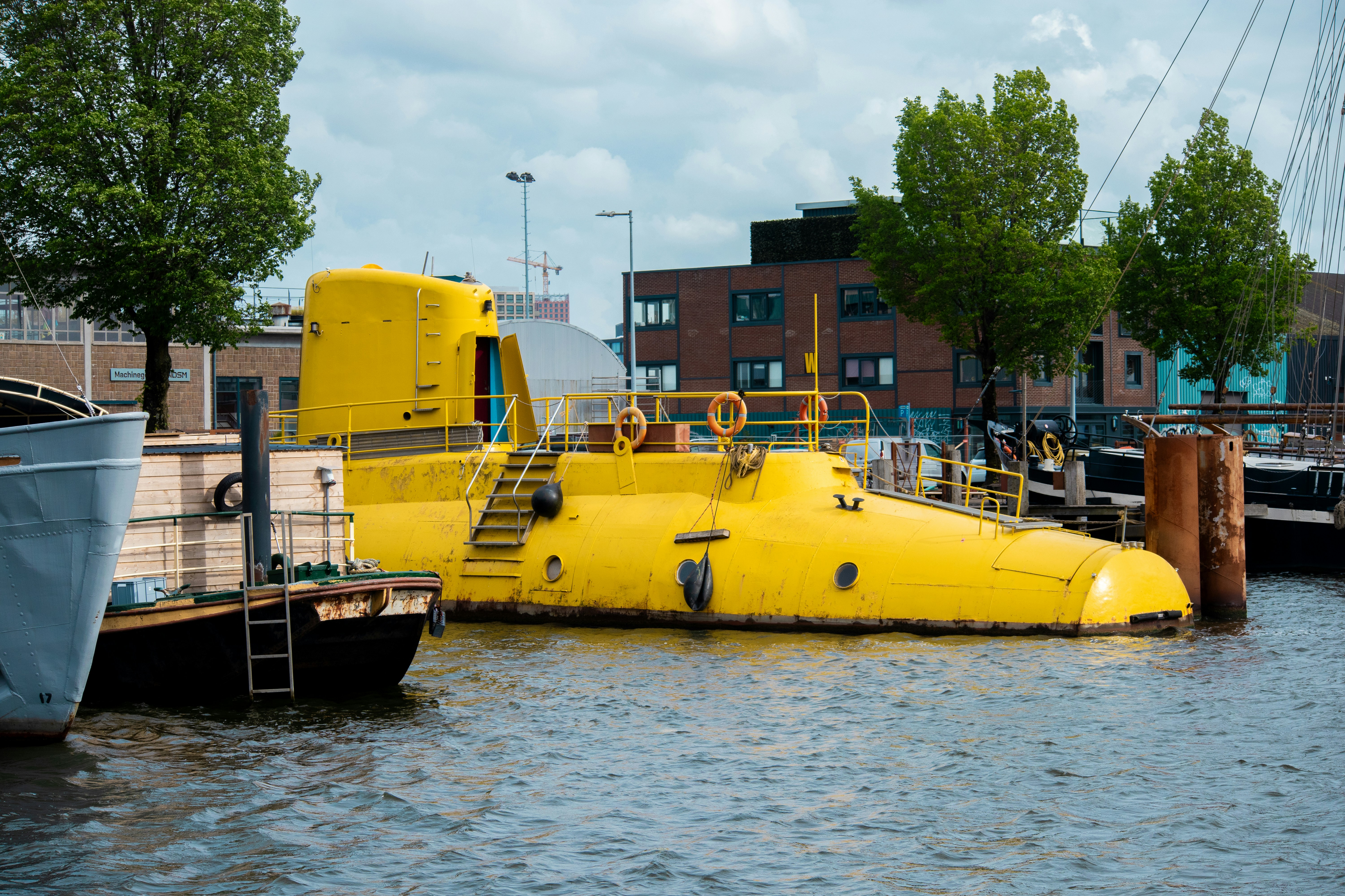 A bright yellow submarine docked in a harbor.