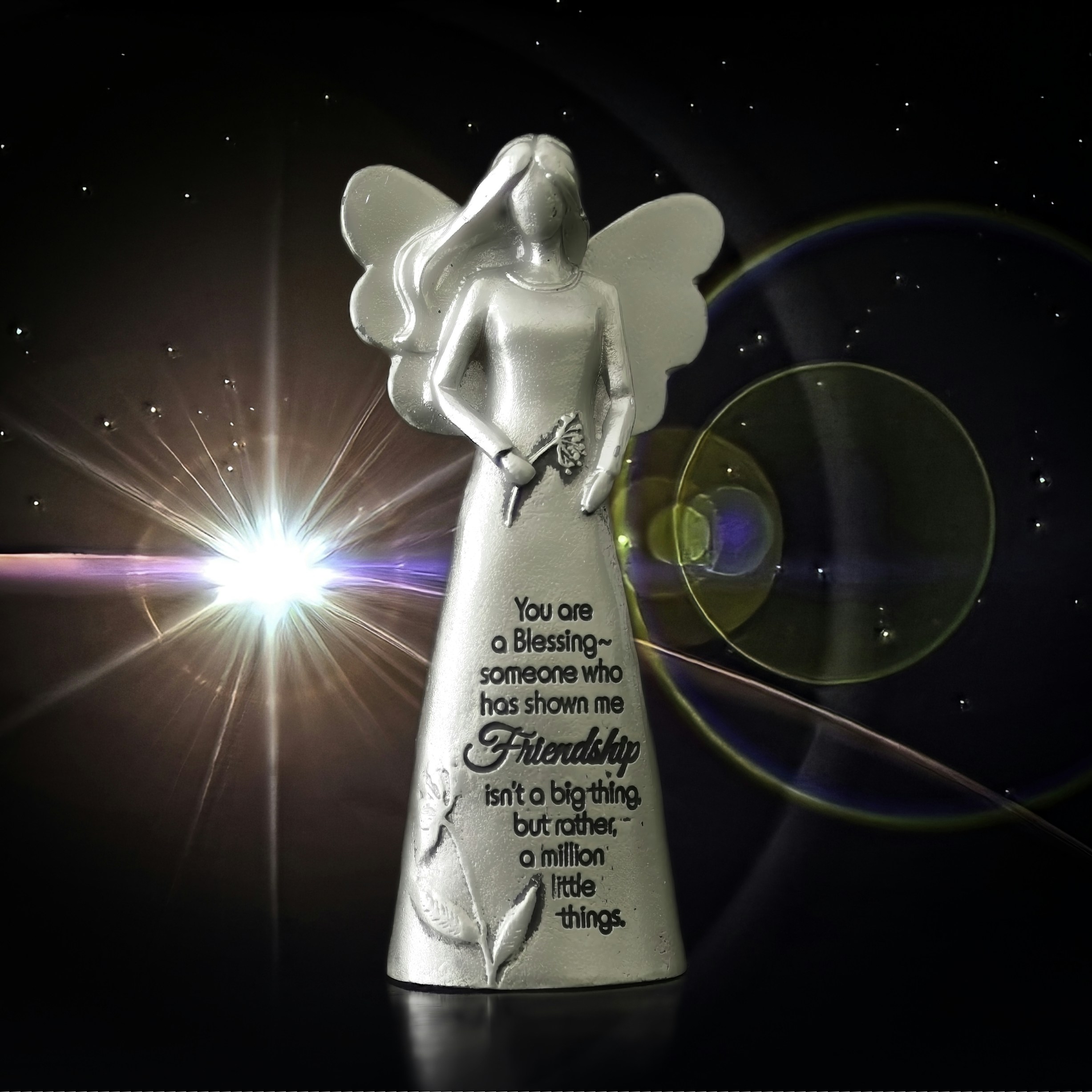 White angel figurine with text and glowing light.