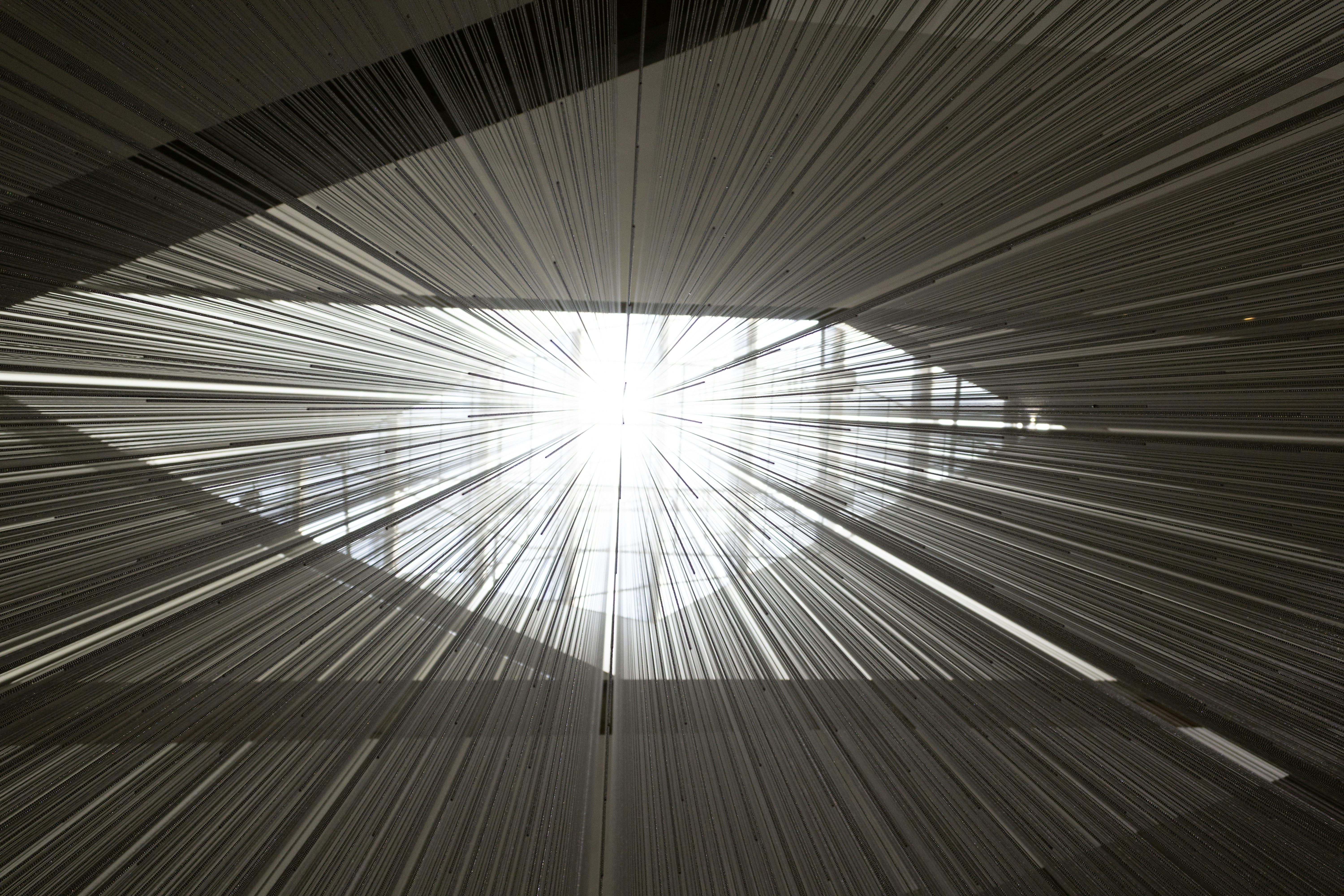 Bright light radiating through a rectangular opening with many lines