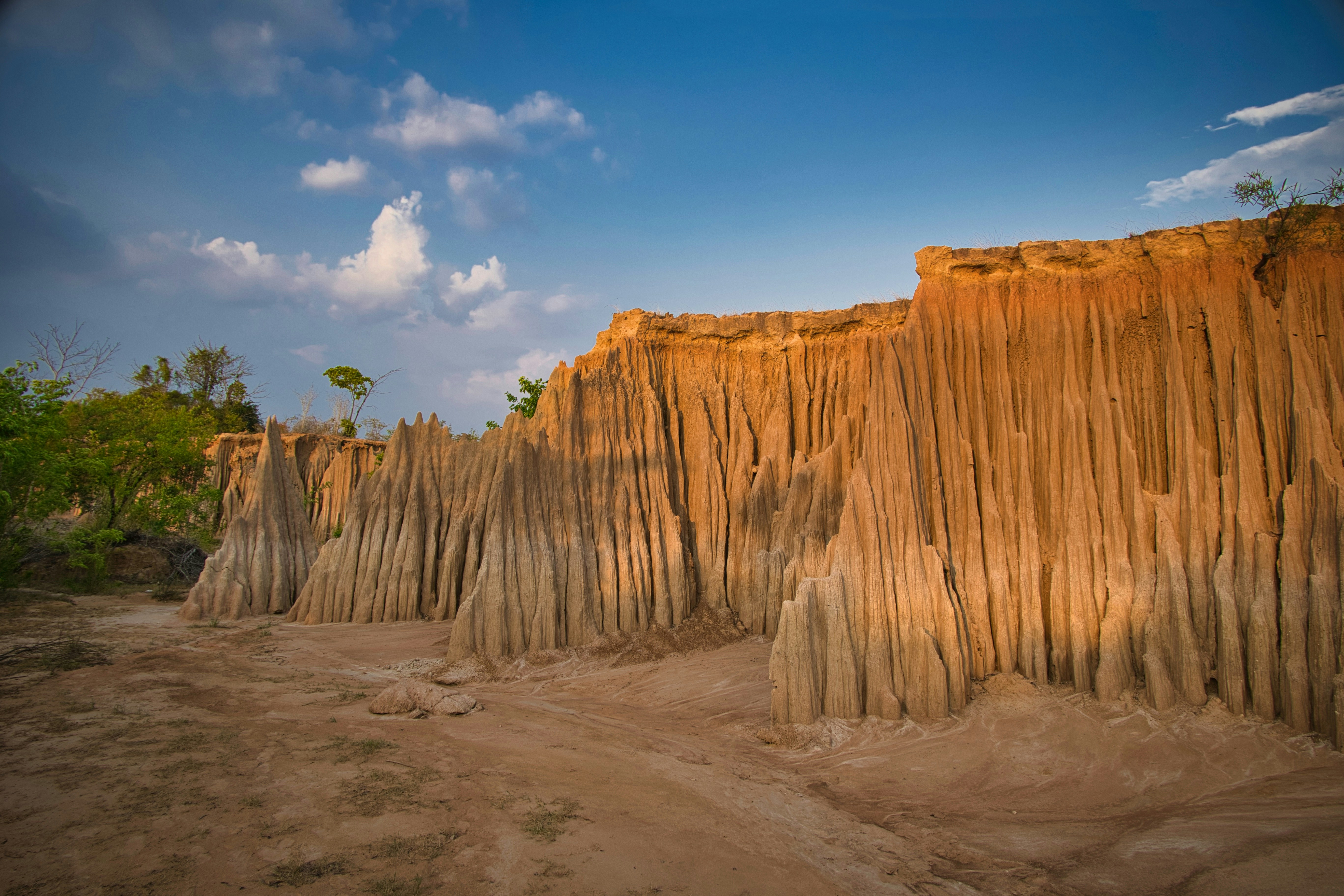Striking eroded earth formations under a clear blue sky