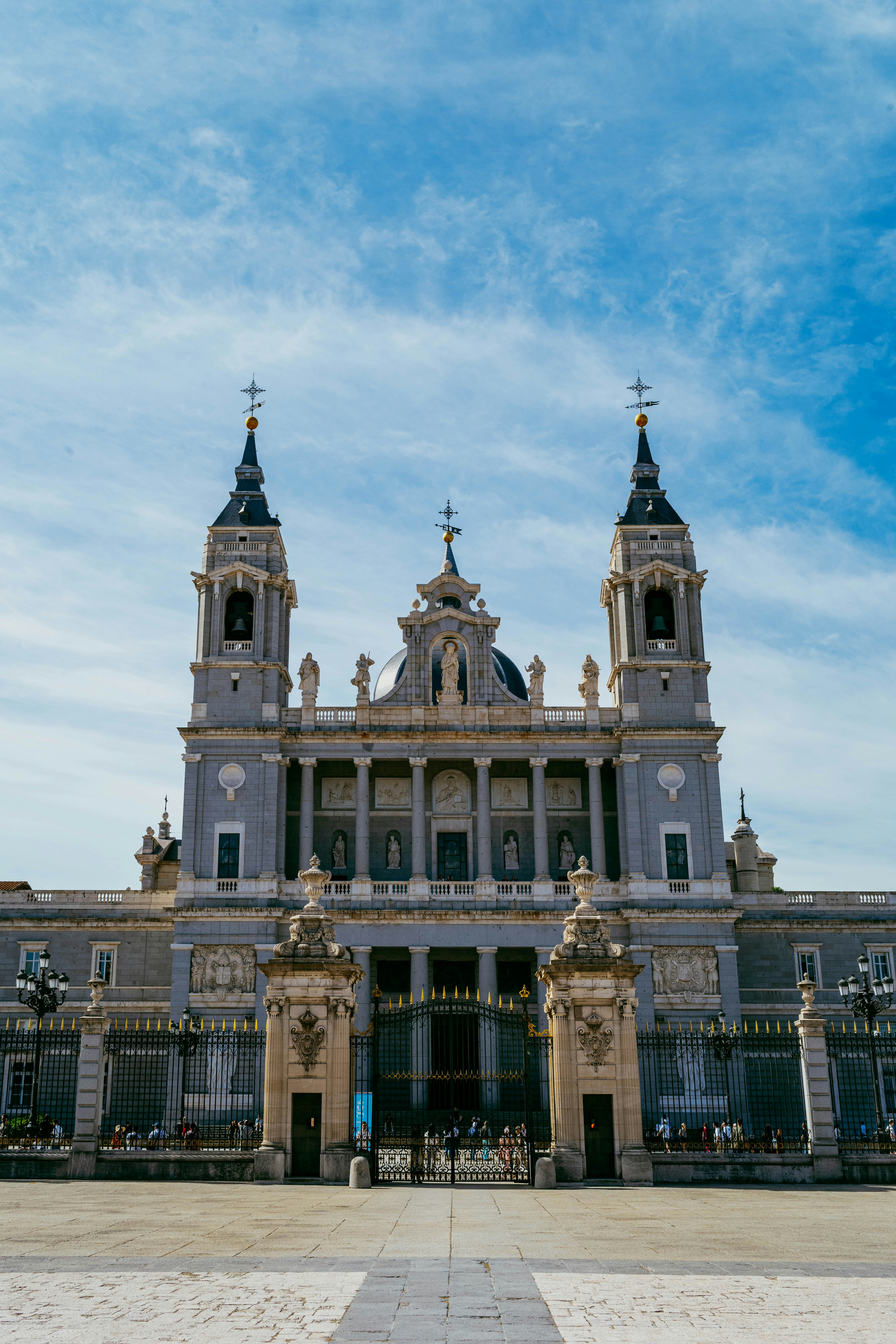 Ornate european cathedral with two towers against blue sky.