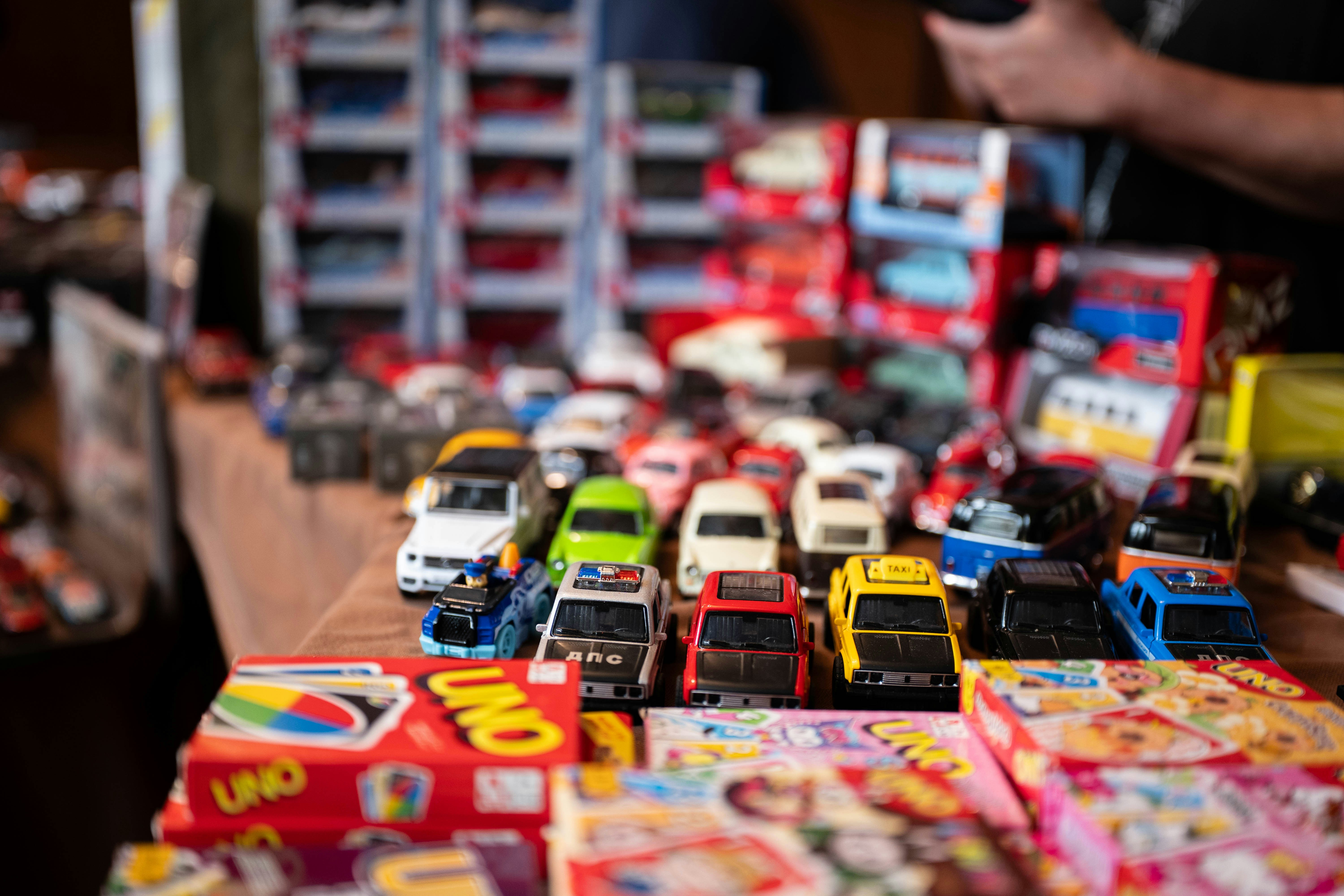 A table filled with many colorful toy cars and games.