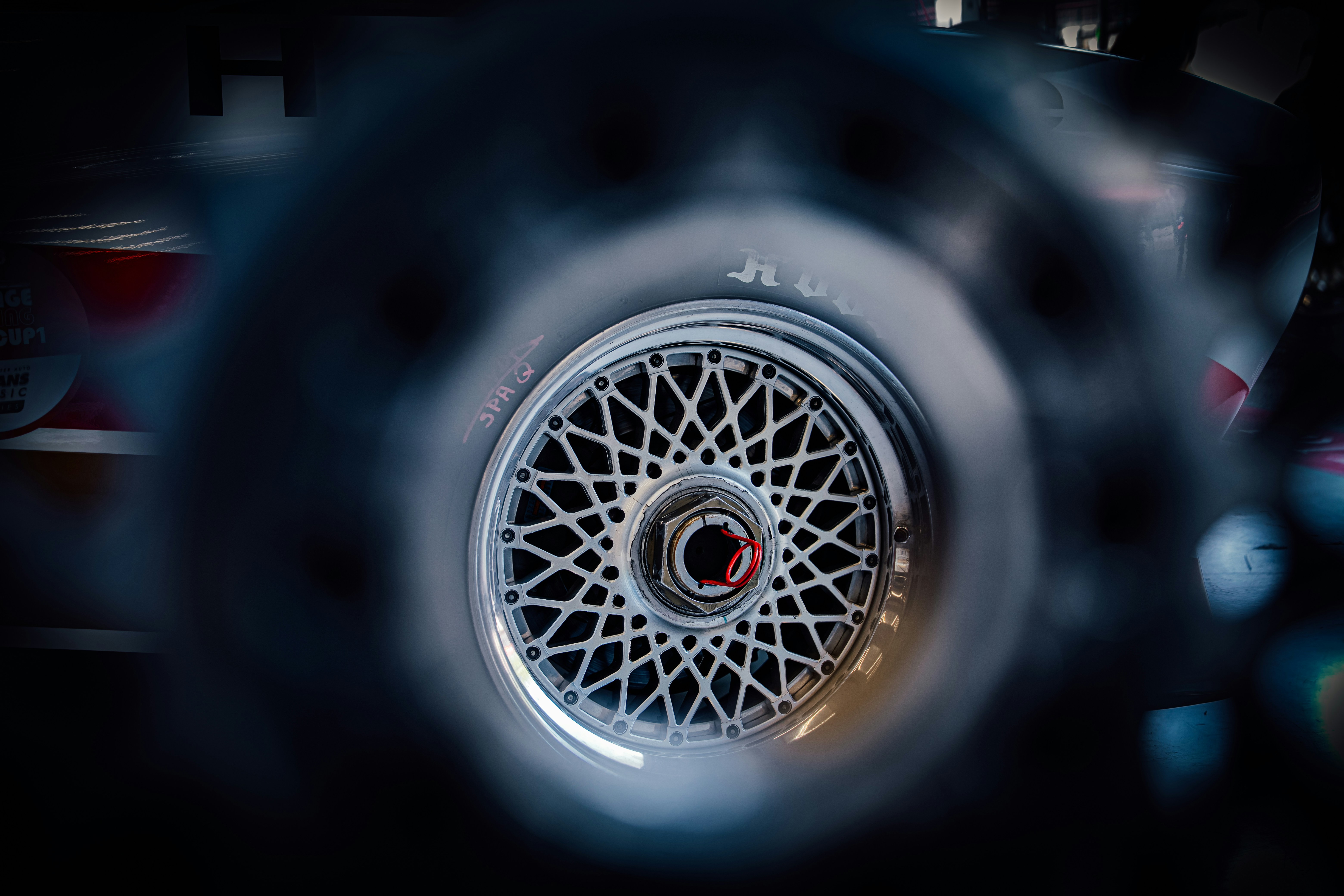 Detailed car wheel with a spoked rim.