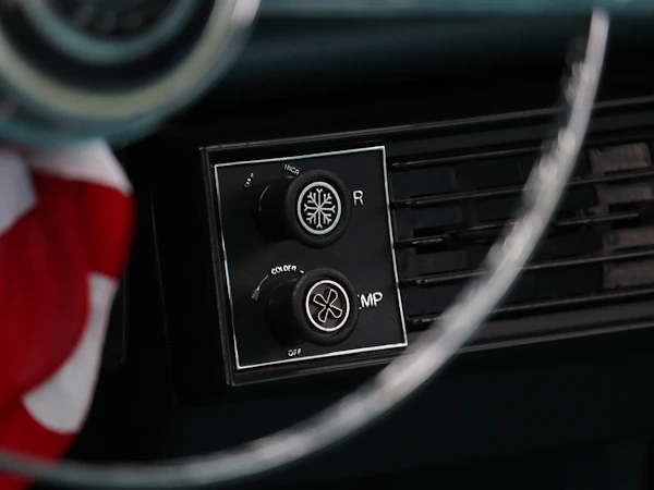 Vintage car dashboard with snowflake-marked air conditioning knobs
